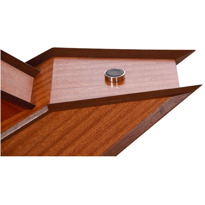 Close-up of a wooden table lamp with a small circular metallic push button.