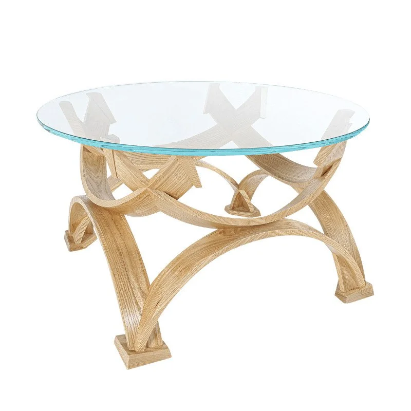A round glass-top table with a curved wooden base.
