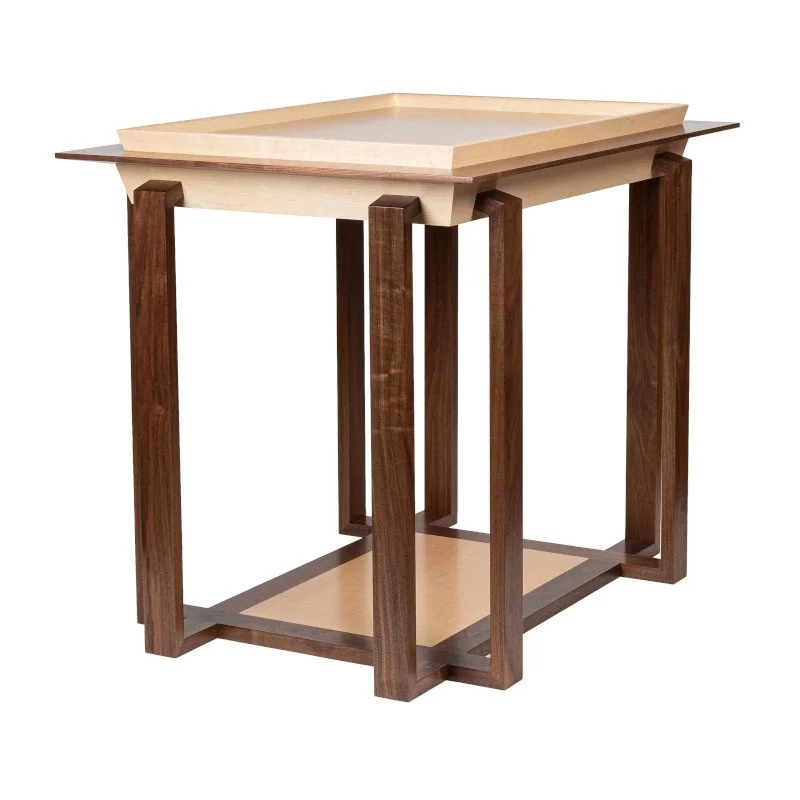 Wooden display table with a light-colored top and base, and dark wood legs.