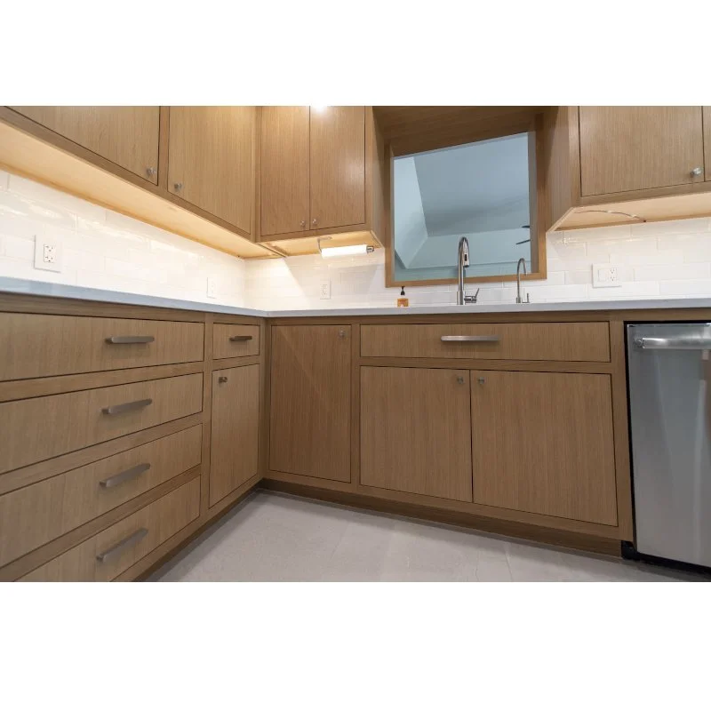 Kitchen with wooden cabinets, white subway tile backsplash, stainless steel dishwasher, and a window above the sink.