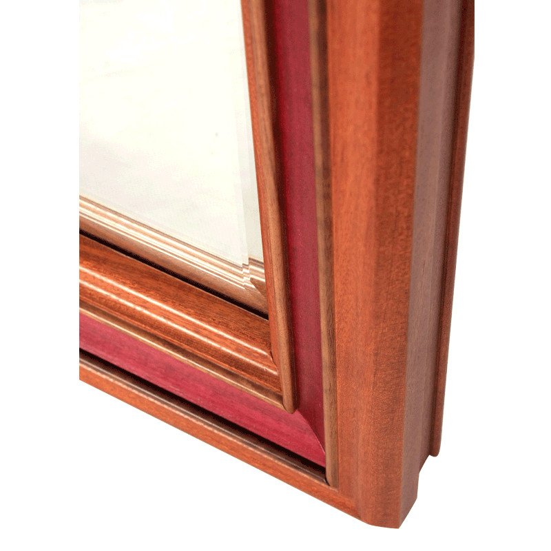 Close-up of a wooden mirror frame corner with exotic hardwoods.