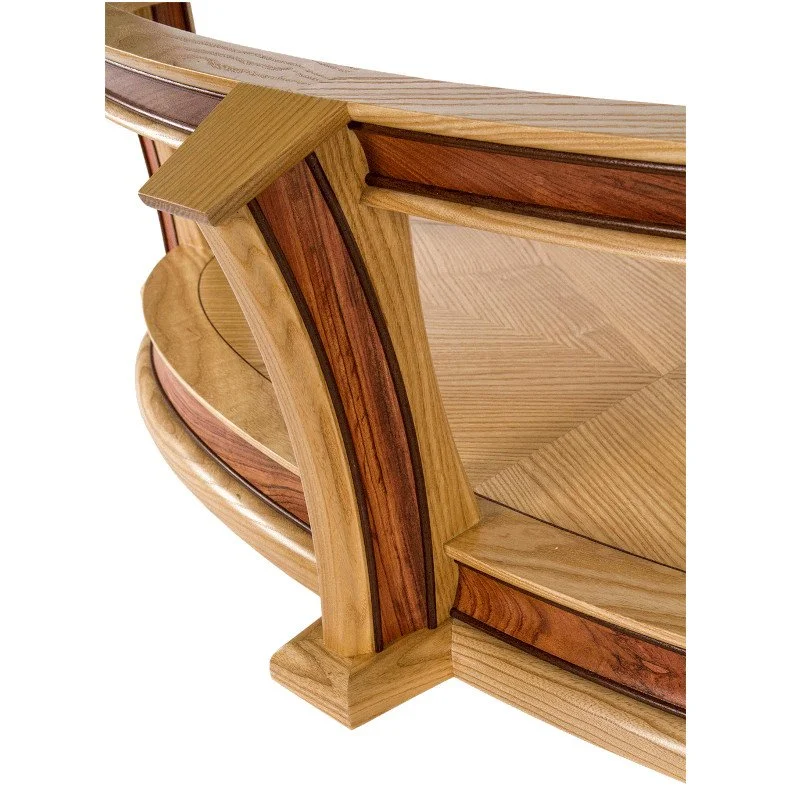 Close-up view of a handcrafted wooden coffee table leg showing wood joinery and layered wood grain patterns.