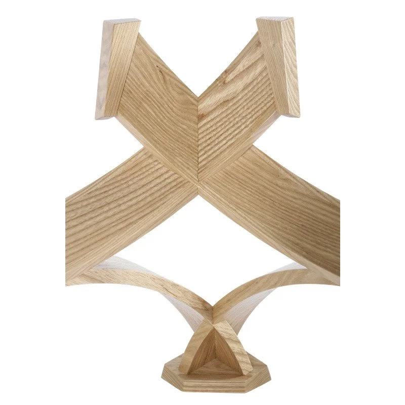 A detail view of a curved modern wooden coffee table base.