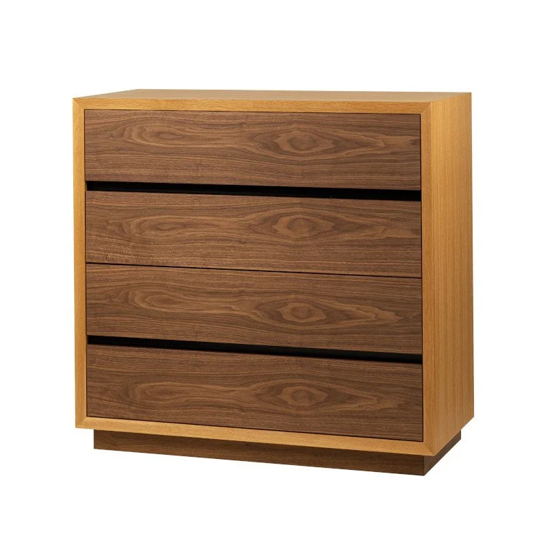 A wooden chest of drawers with four drawers, in a light-colored wood frame and darker wood drawer fronts.