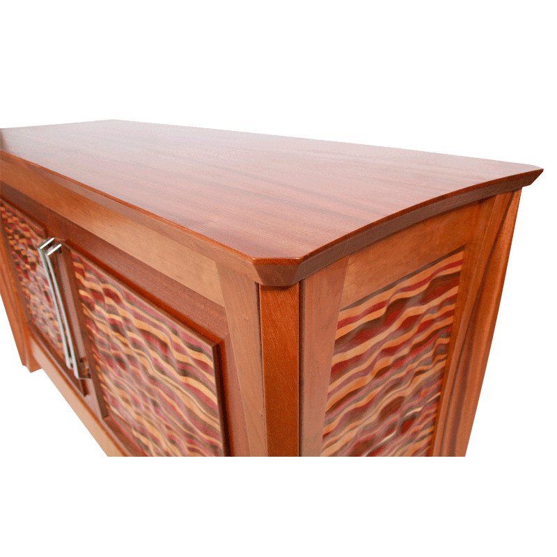 Wooden cabinet with a curved top and colorful patterned panels on the sides and doors.