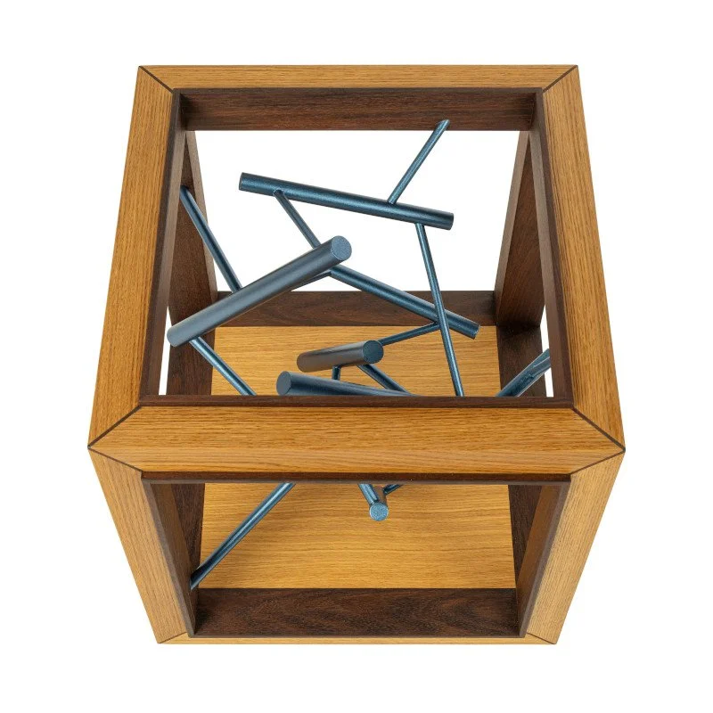 A wooden side table with a sculpture in the middle.