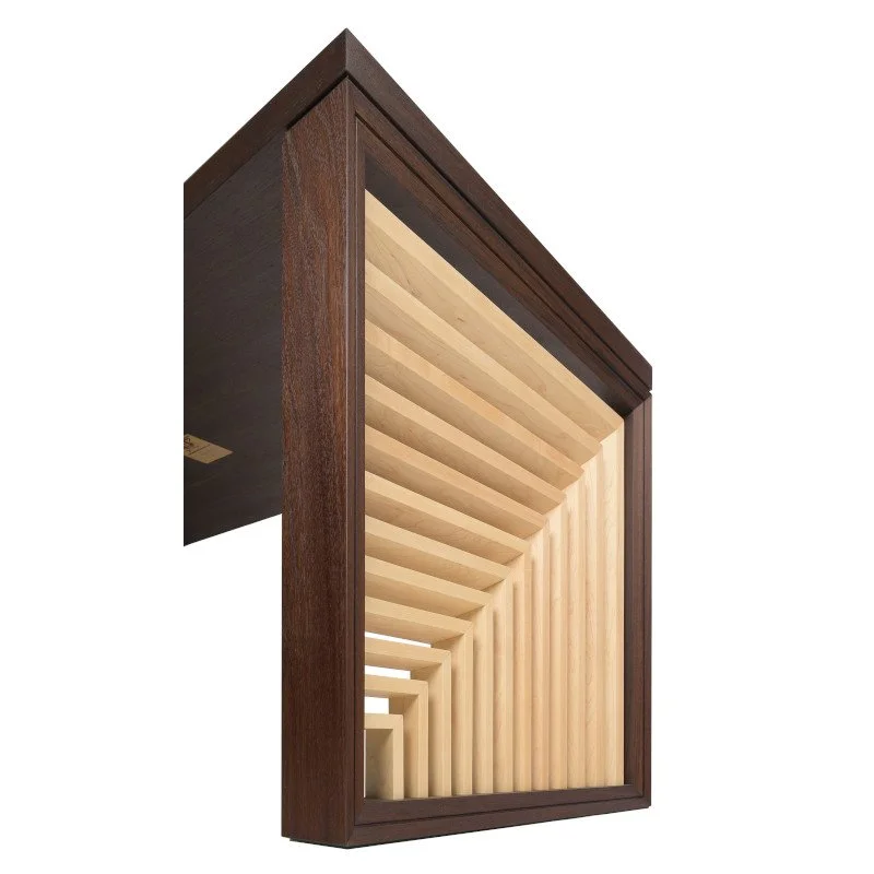 A wooden framed desk leg with angled, evenly spaced wooden slats inside.