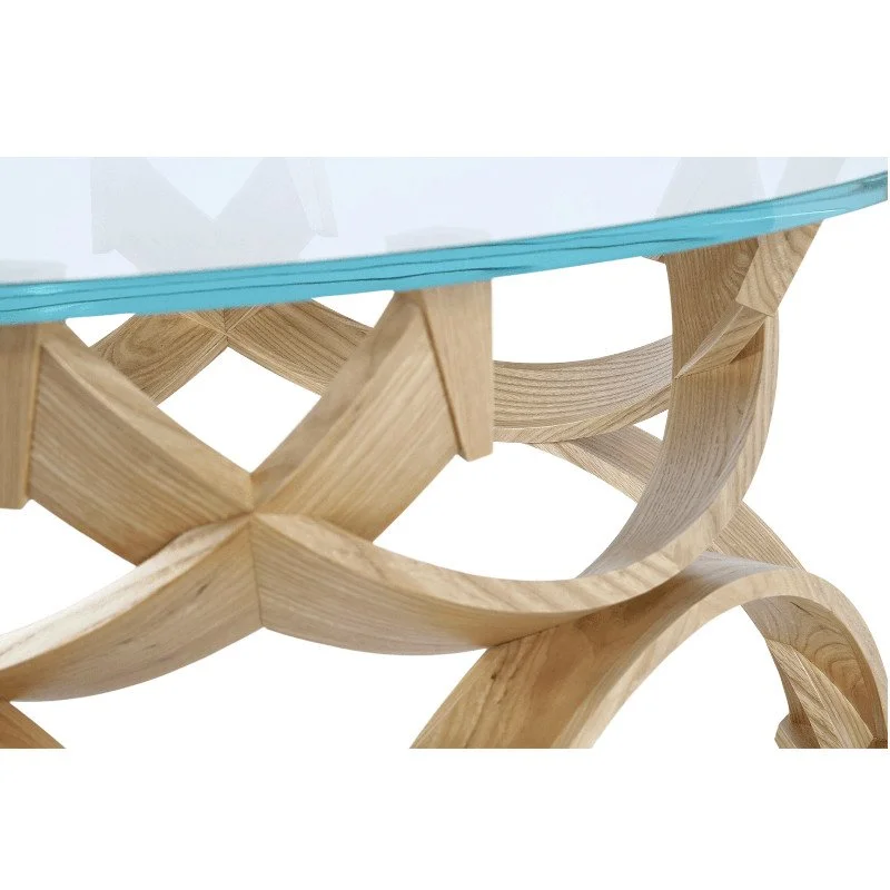 Close-up of a wooden table with a glass top and intricate curved wooden base.