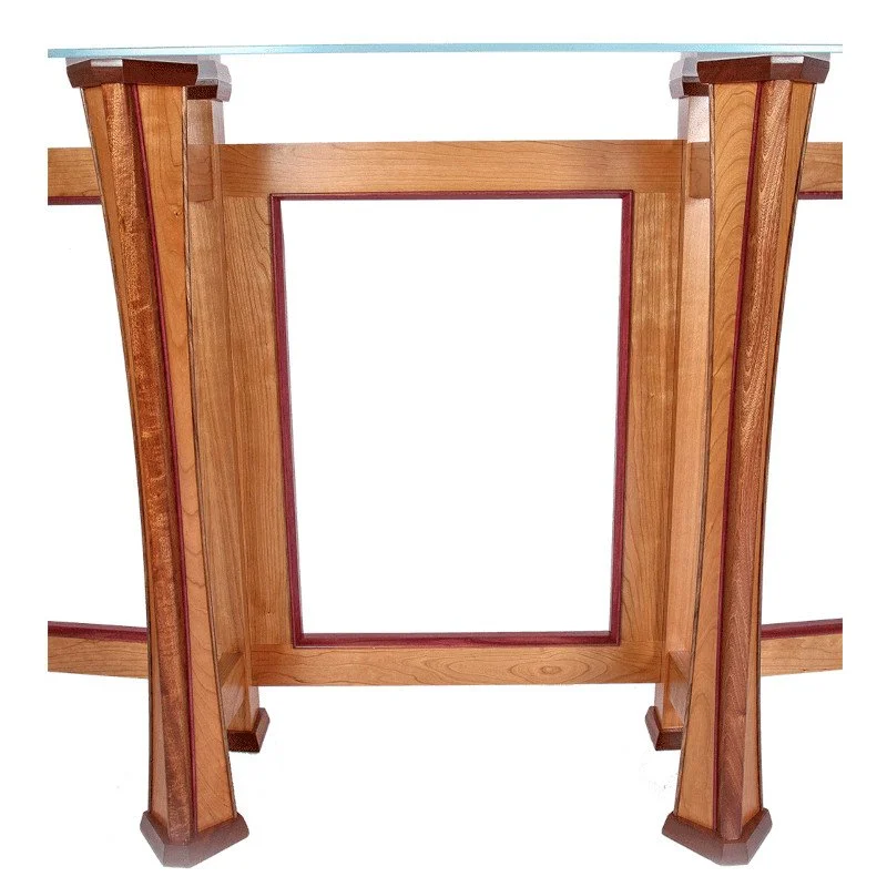 Wooden table leg with a glass top surface visible from below.