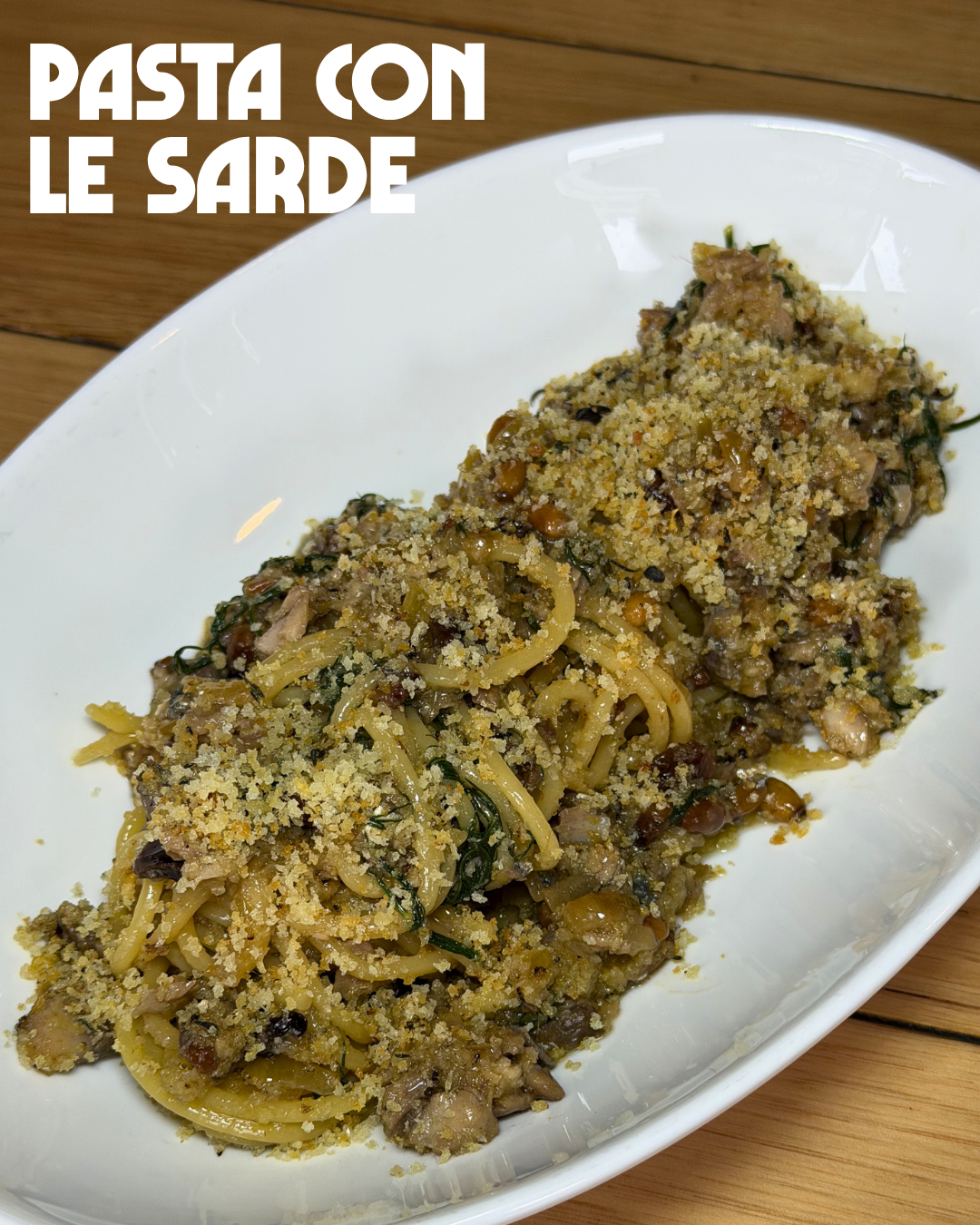 Bucatini pasta with sardines, fennel, pine nuts and currants with breadcrumbs on a plate