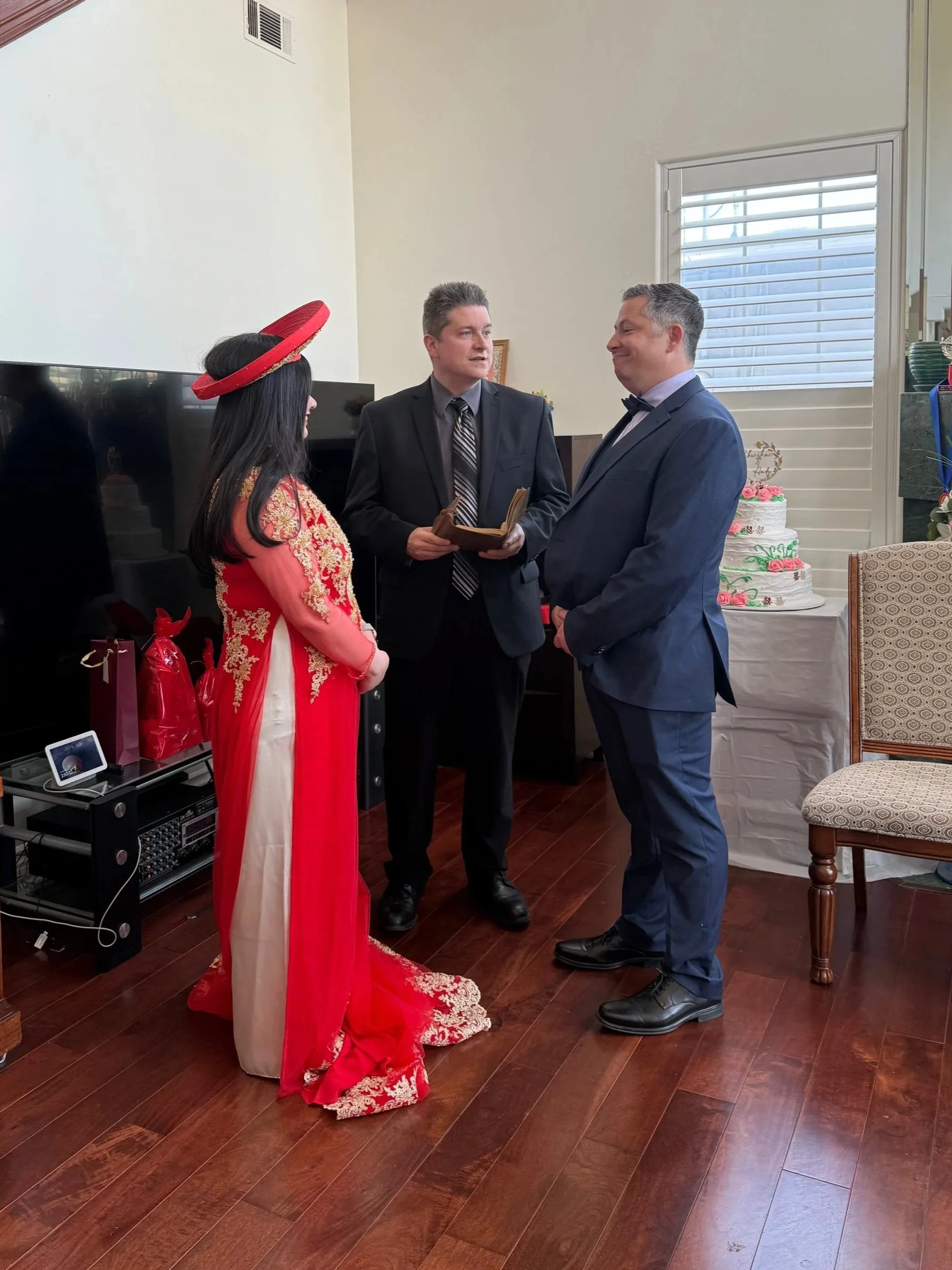 A wedding ceremony with a bride and groom standing with Reverend James
