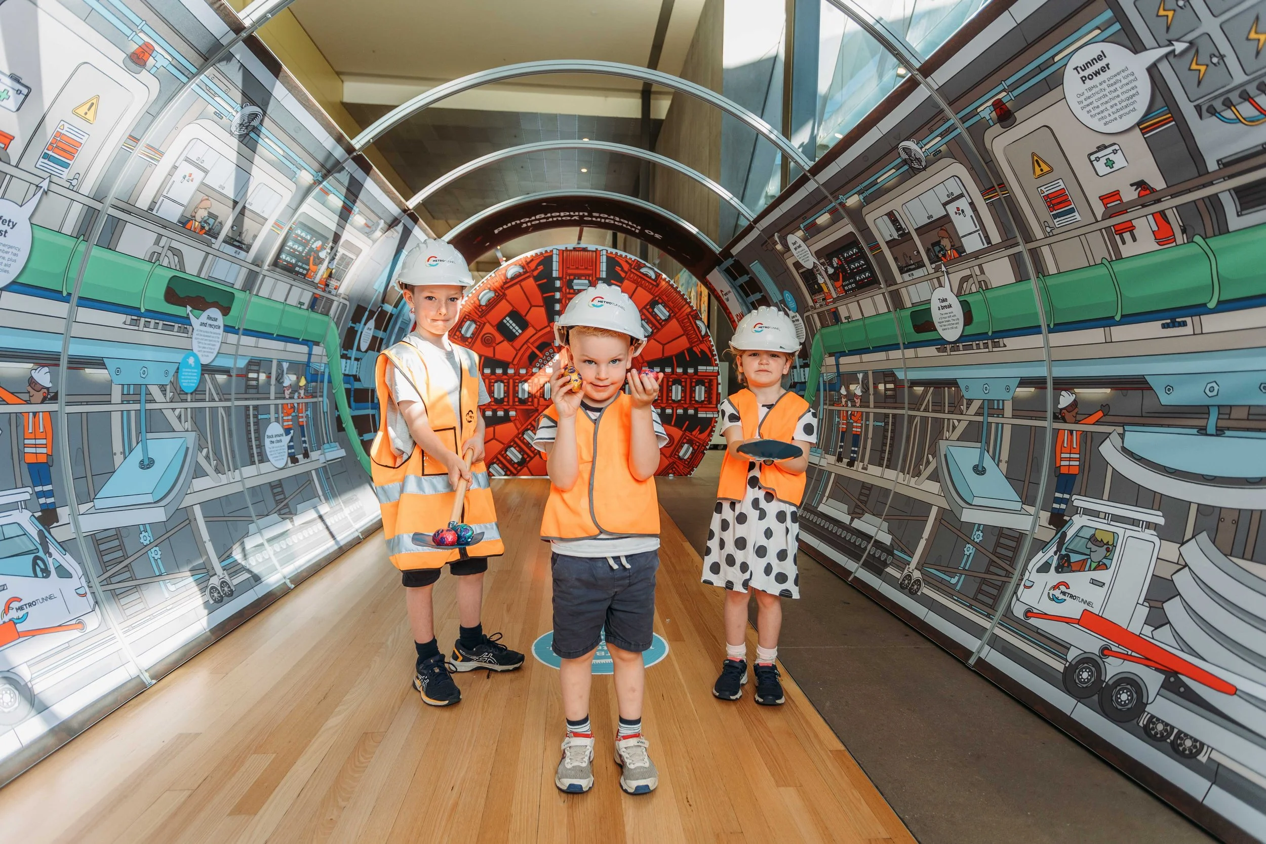 Young builders with their Easter treasures inside the illustrated tunnel