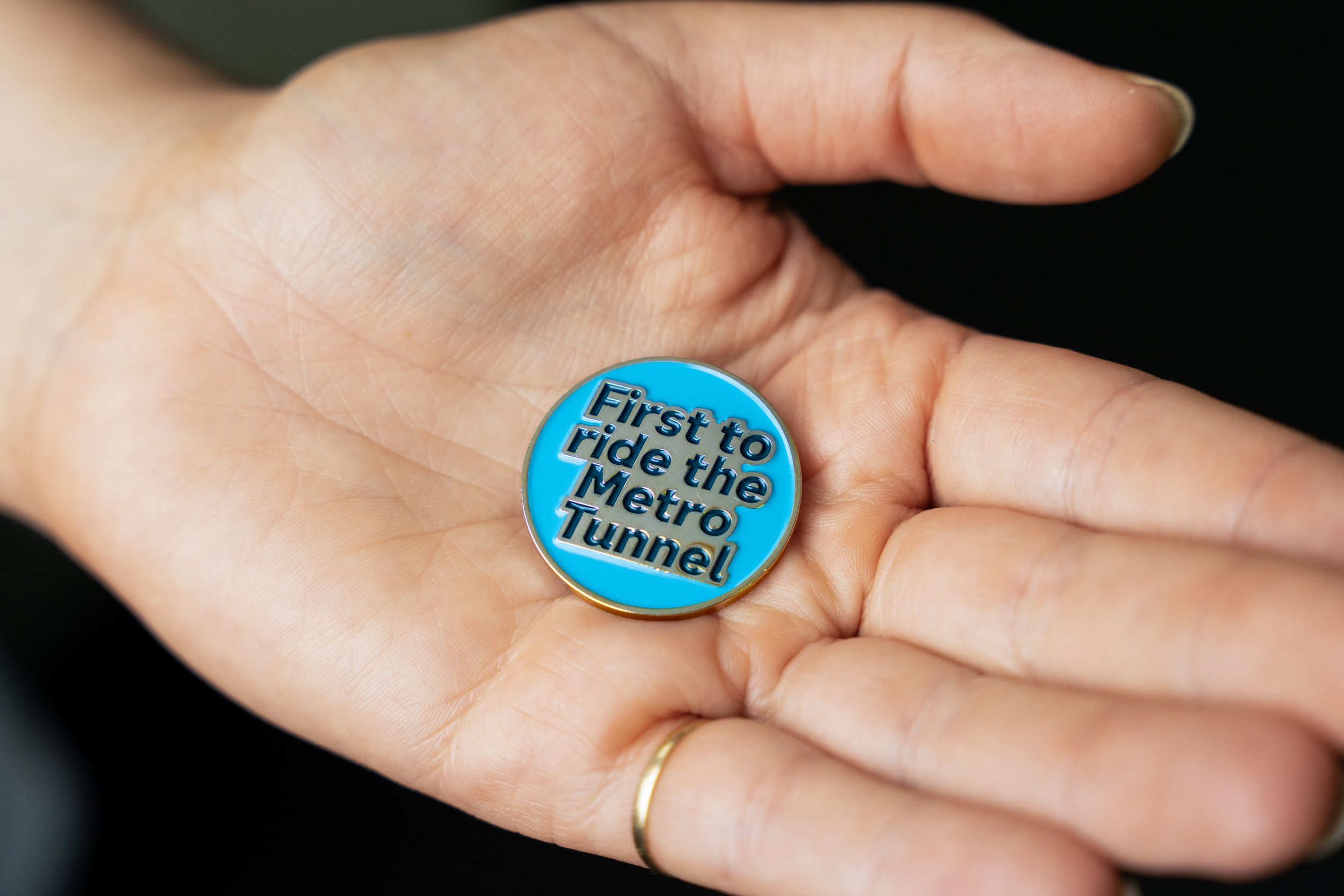 A commemorative “first to ride” pin badge