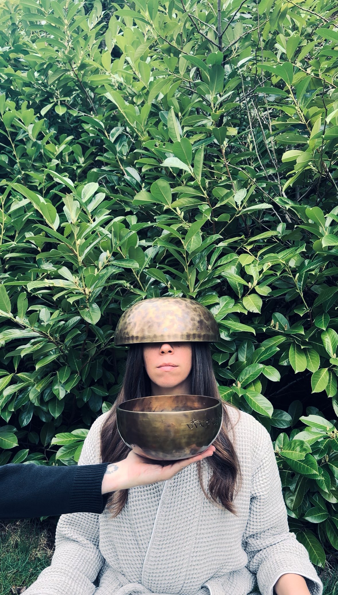 Woman receiving a sound healing session using crown chakra bowl