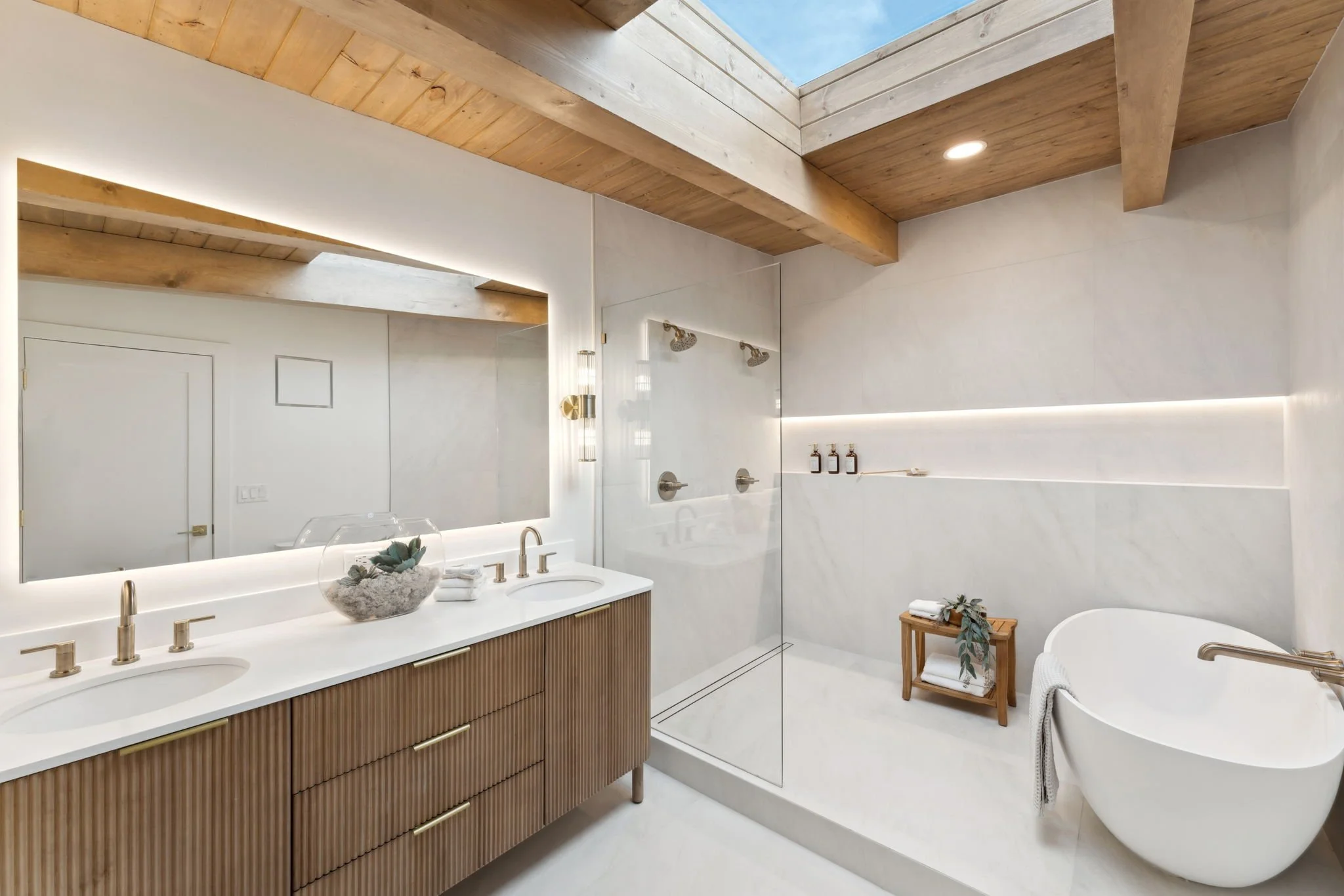 Luxury bathroom renovation featuring a freestanding tub, custom vanity, walk-in shower, and premium finishes.