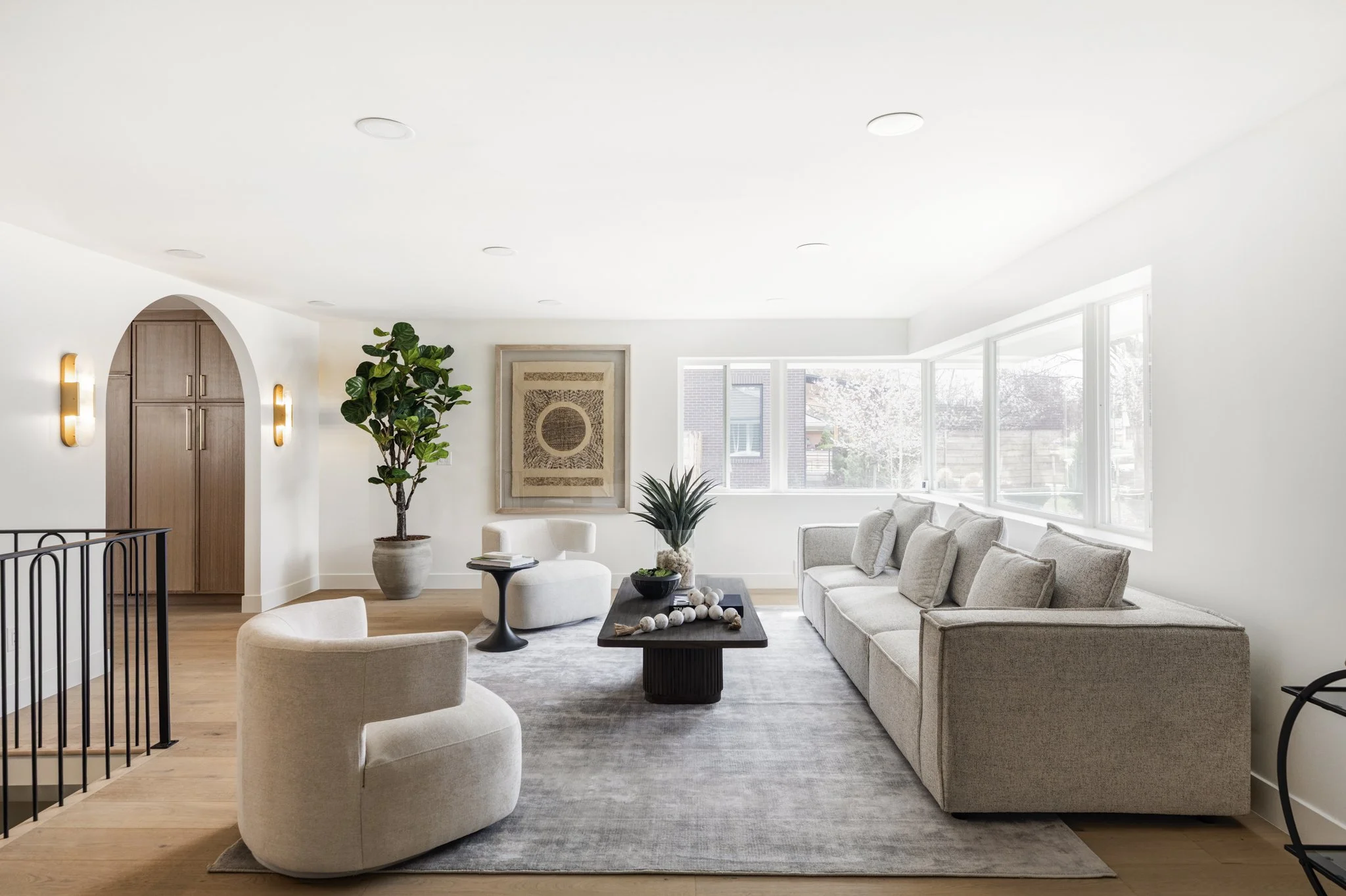 Modern luxury living room with large windows, open floor plan, and premium finishes.
