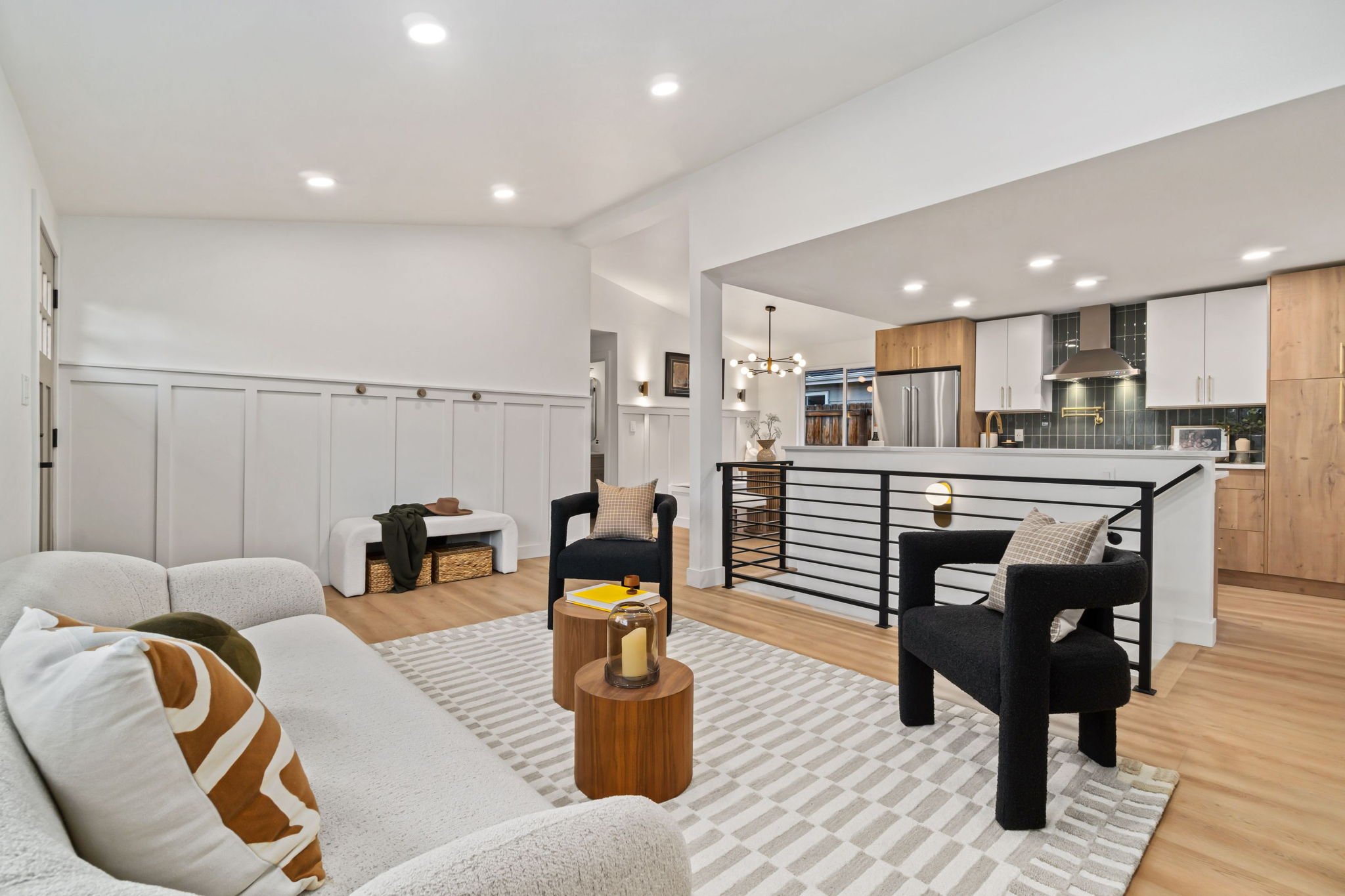 Modern luxury living room with an open concept into a kitchen with white oak cabinets in Sloan's Lake, Denver, Colorado