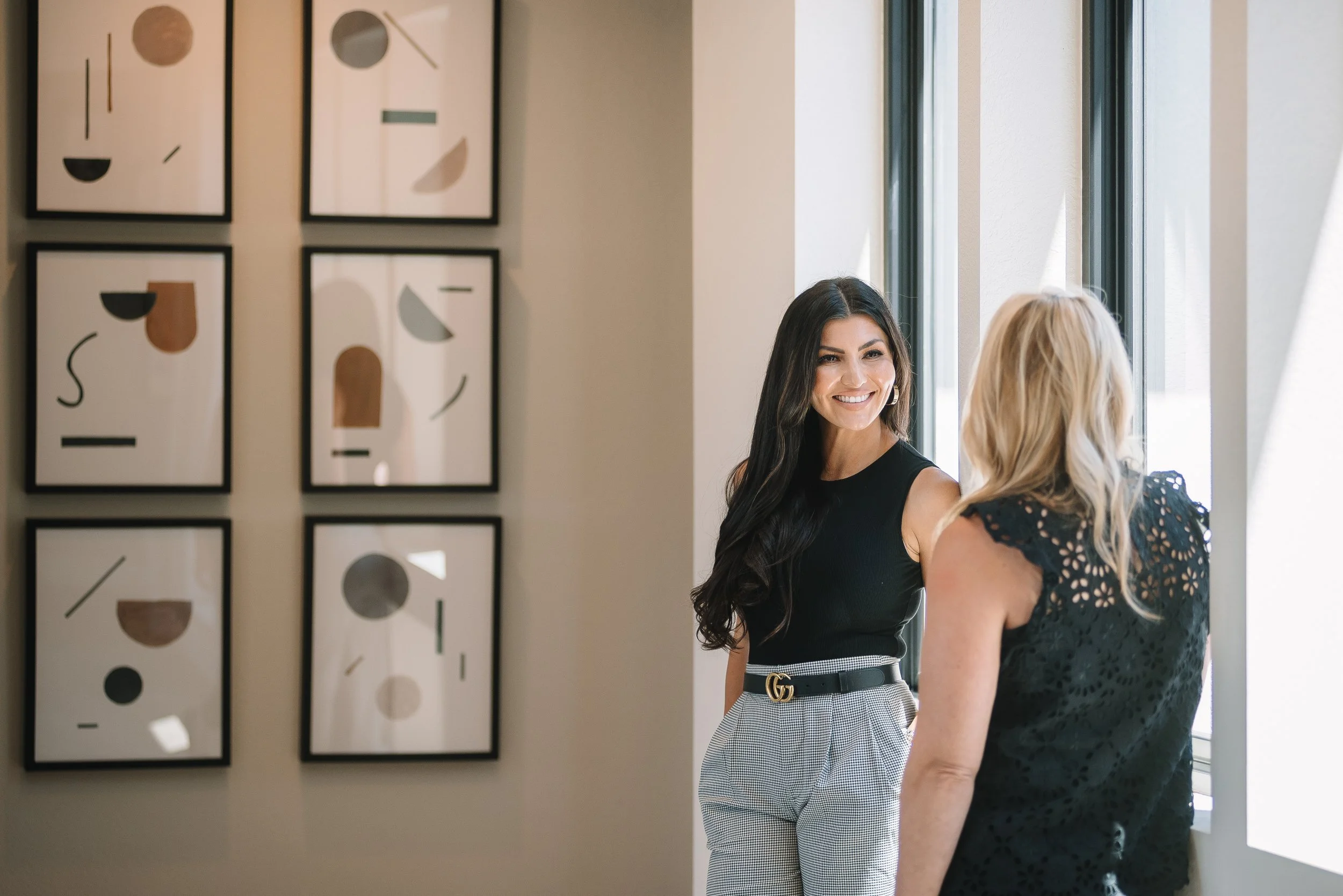 Ashley Lowery of The Lowery Group discussing the Denver real estate market with a client.