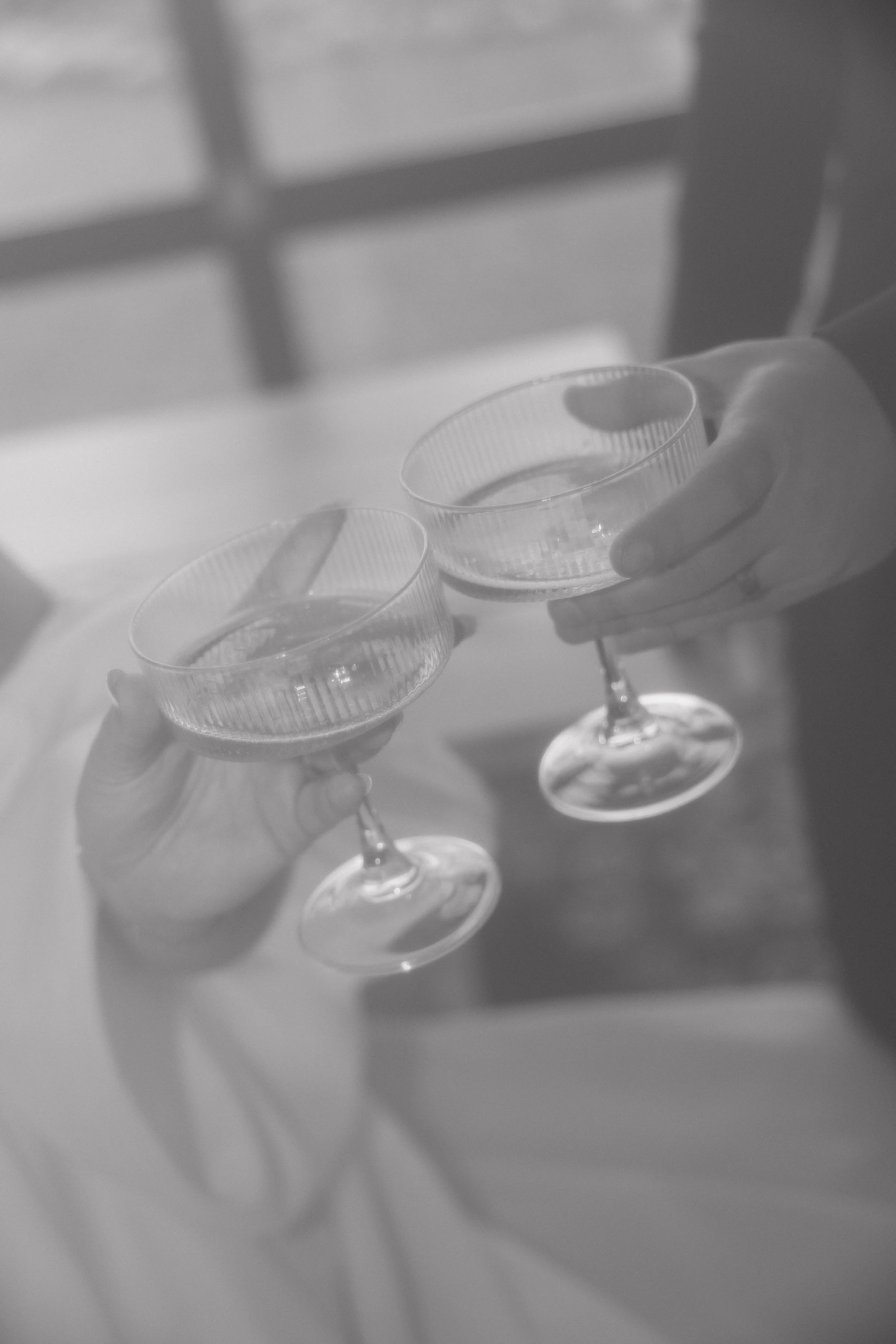 Two people holding champagne glasses in a toast.