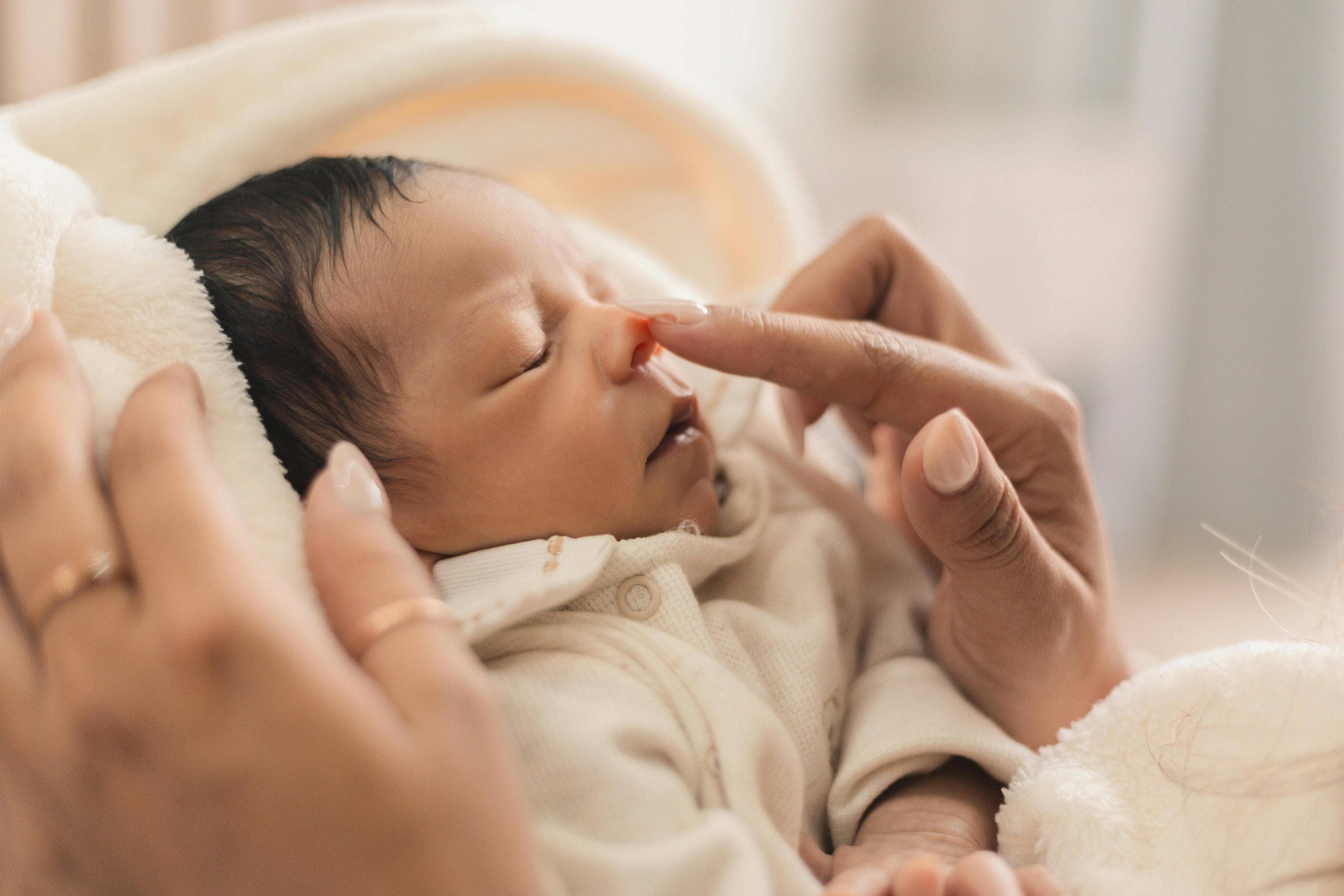 newborn baby napping with postpartum doula