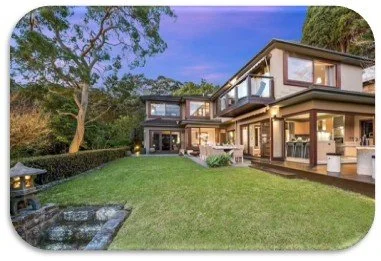 Modern house with large windows, a spacious backyard with a lawn, and outdoor seating area