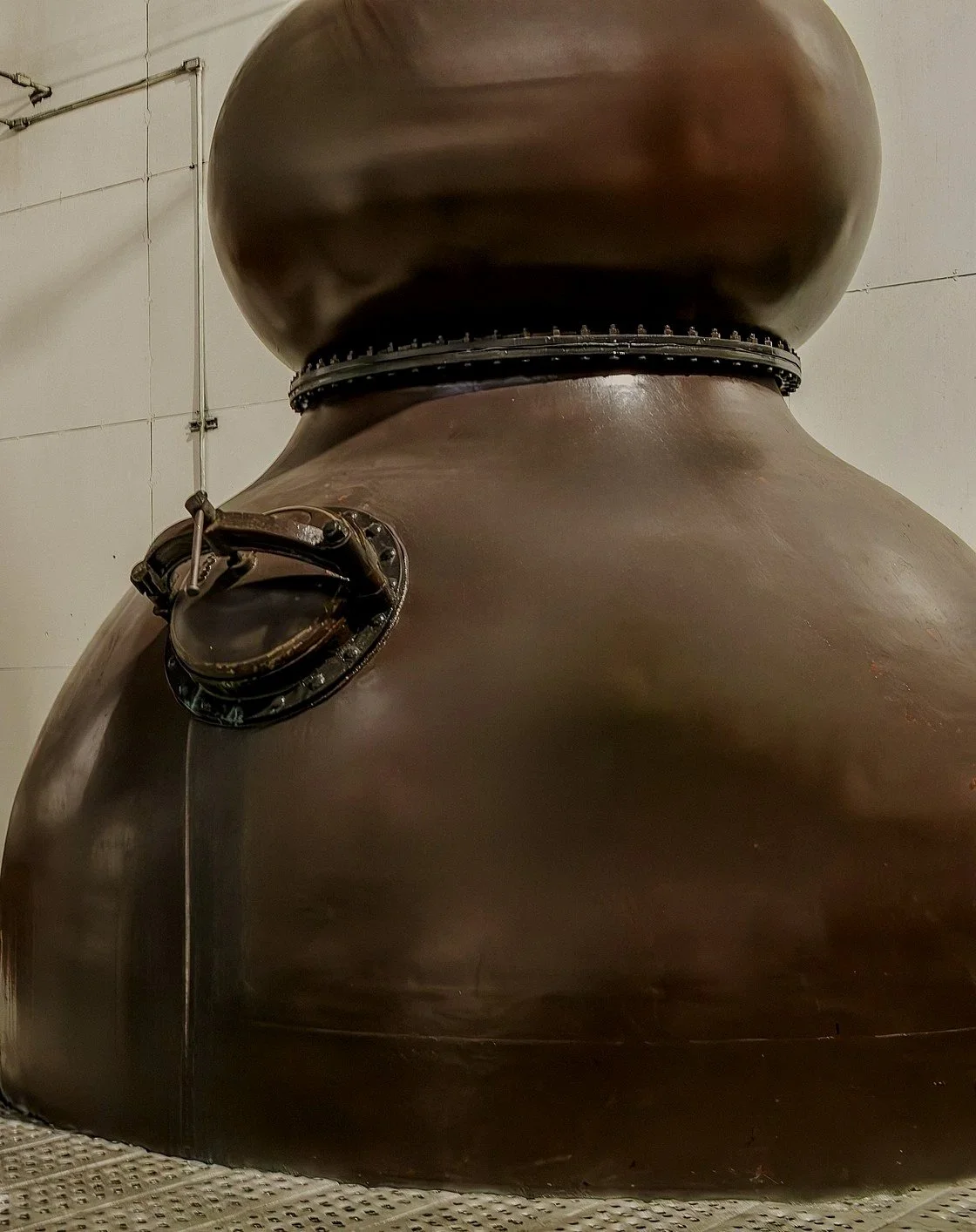 Copper pot still at distillery in Scotland