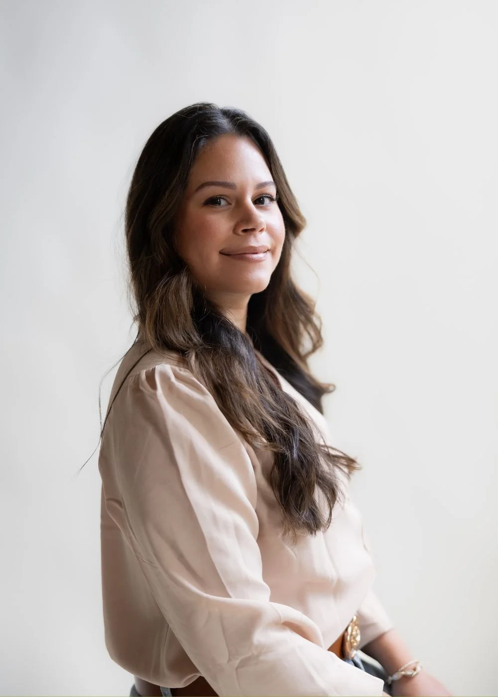Licensed Marriage and Family Therapist in Connecticut, Gily Roselle, perinatal therapist sitting on therapy couch.