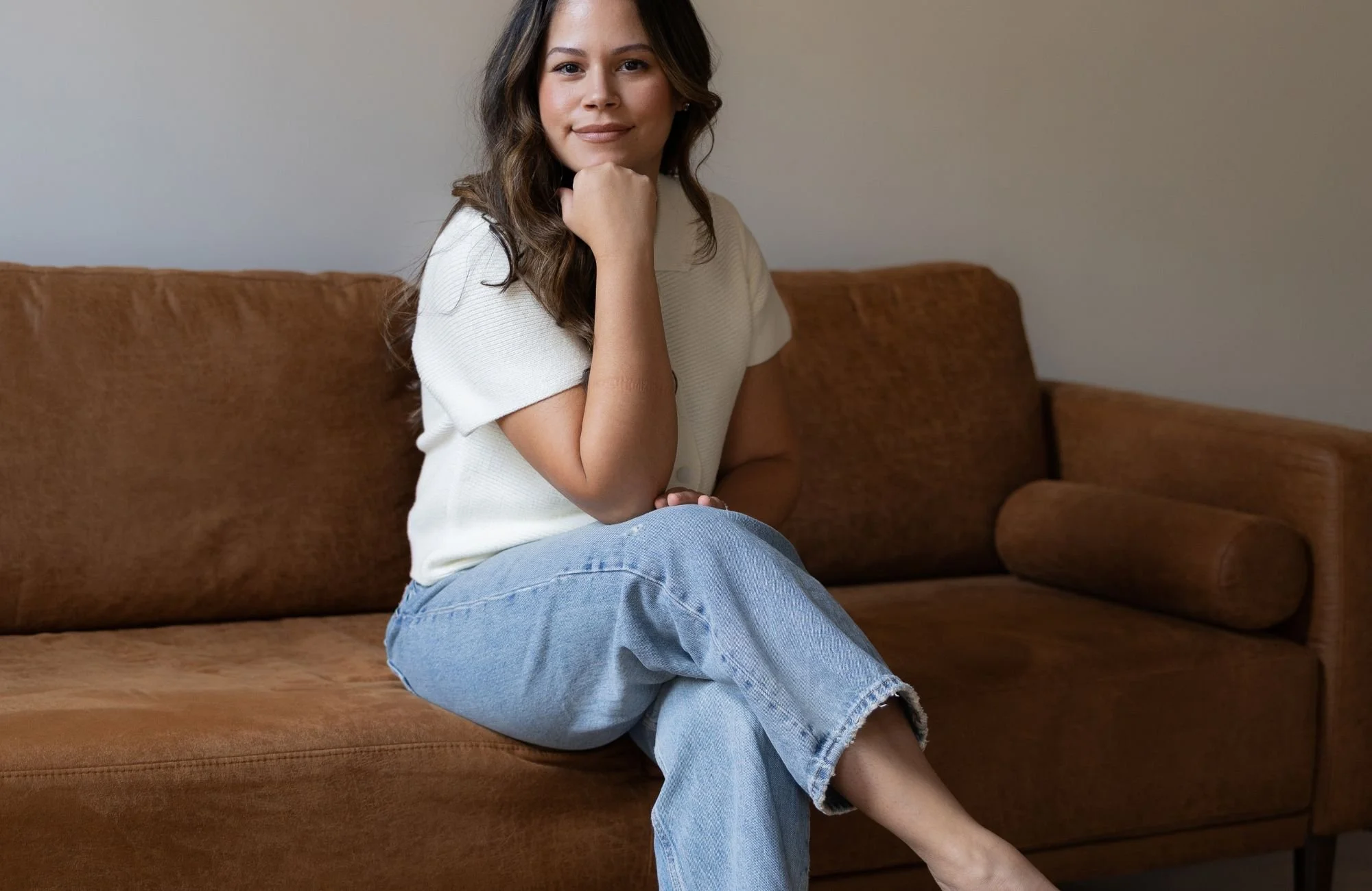 Licensed Marriage and Family Therapist in Connecticut , Gily Roselle, perinatal therapist sitting on therapy couch.