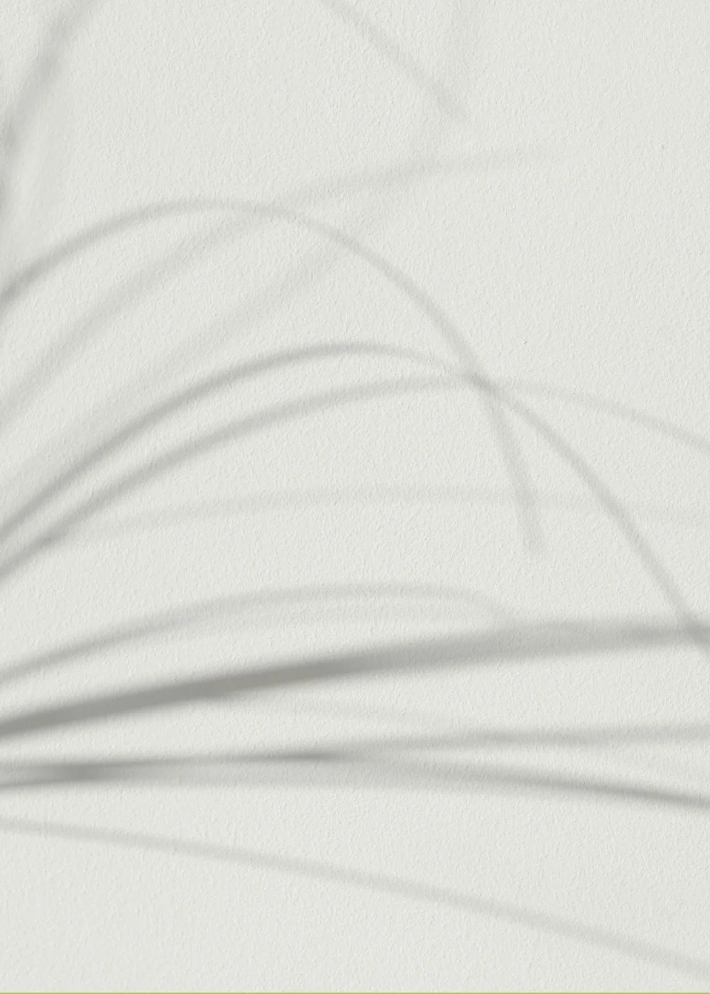 Close-up of a textured white surface with soft, curved shadows cast across it.