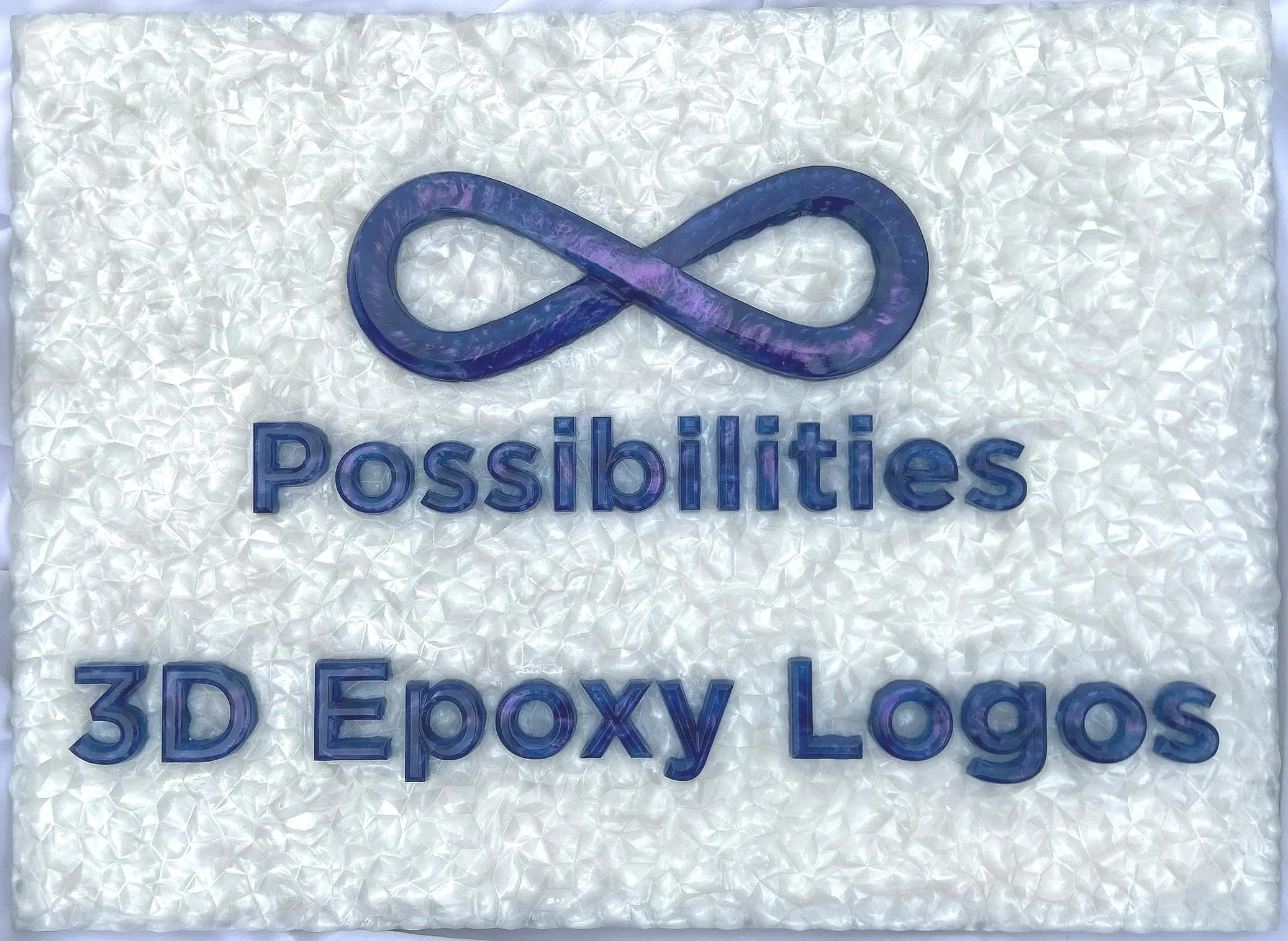 A 3D epoxy logo with text that displays "Infinite Possibilities 3D Epoxy Logos". The letters shift colors between purple and blue-green. The background looks like it's made of white crystals in a lattice.