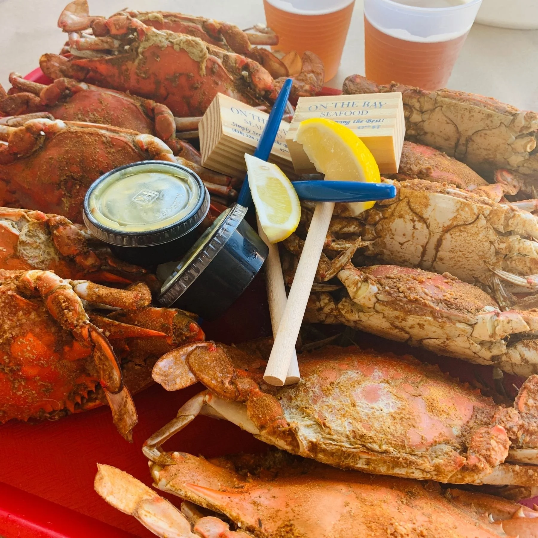 Steamed seafood crab styled outside on a patio with lemons and crab mallets