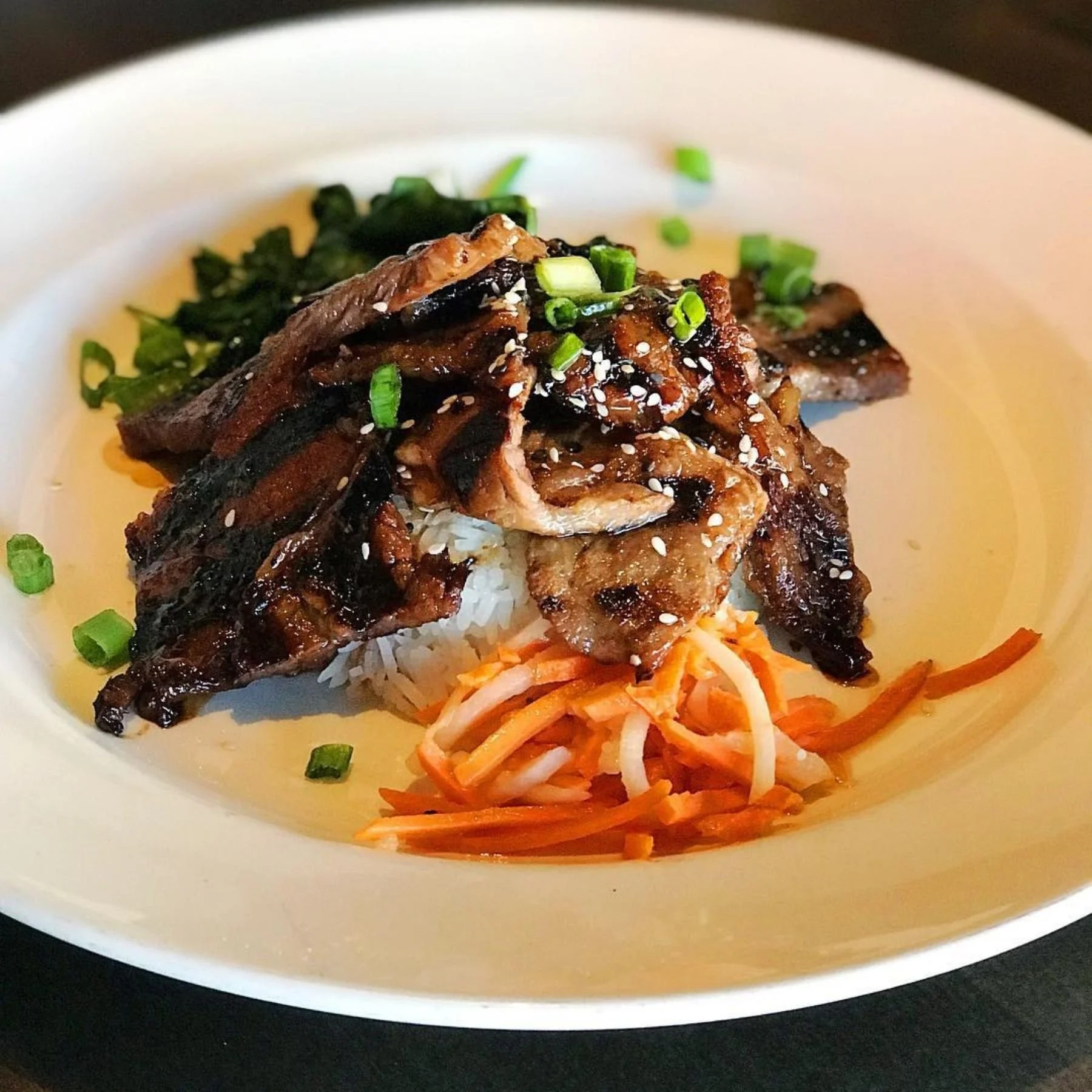 Korean beef and jasmine rice bowl photographed in a modern Asian restaurant