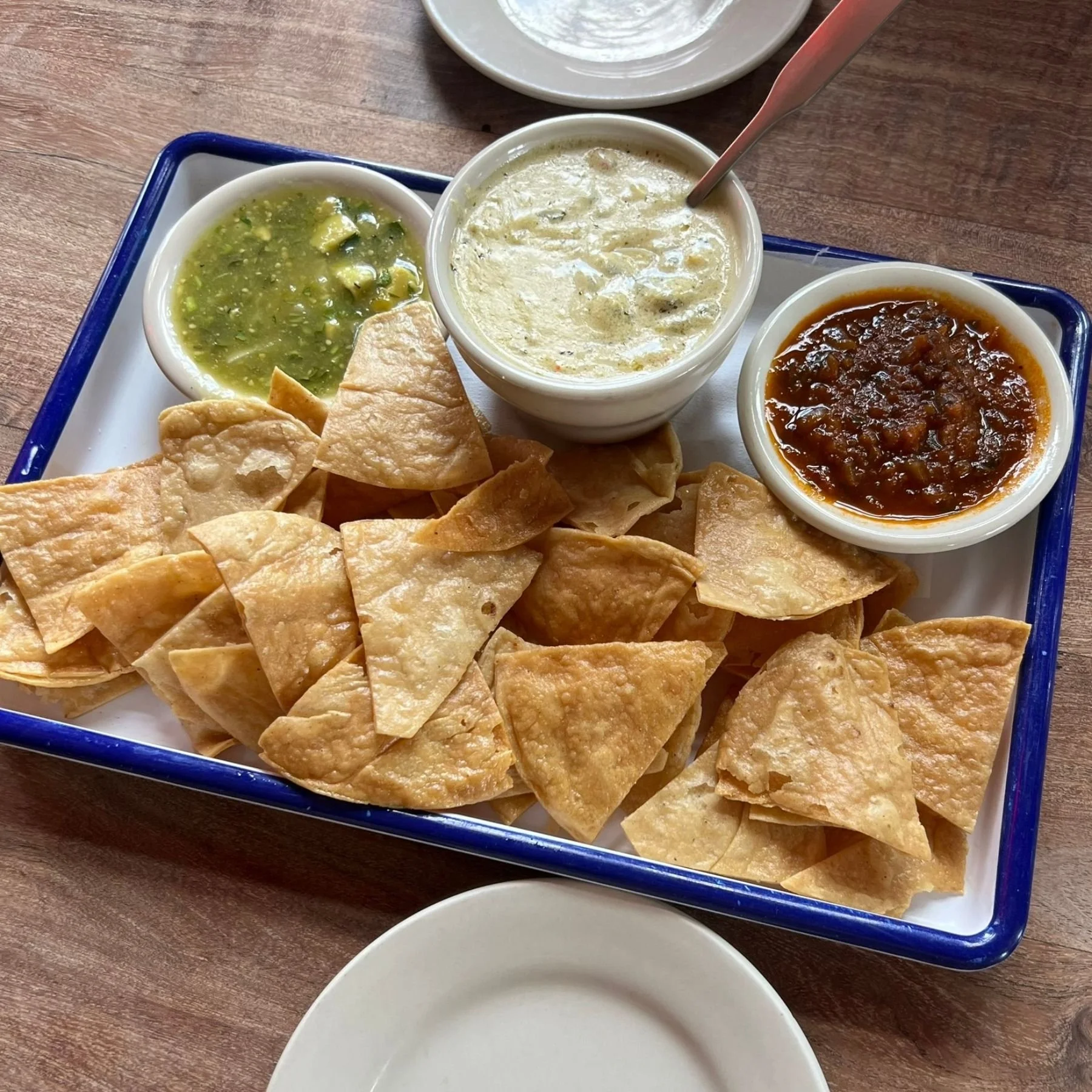 Fresh salsa served with guacamole and tortilla chips at a casual patio restaurant