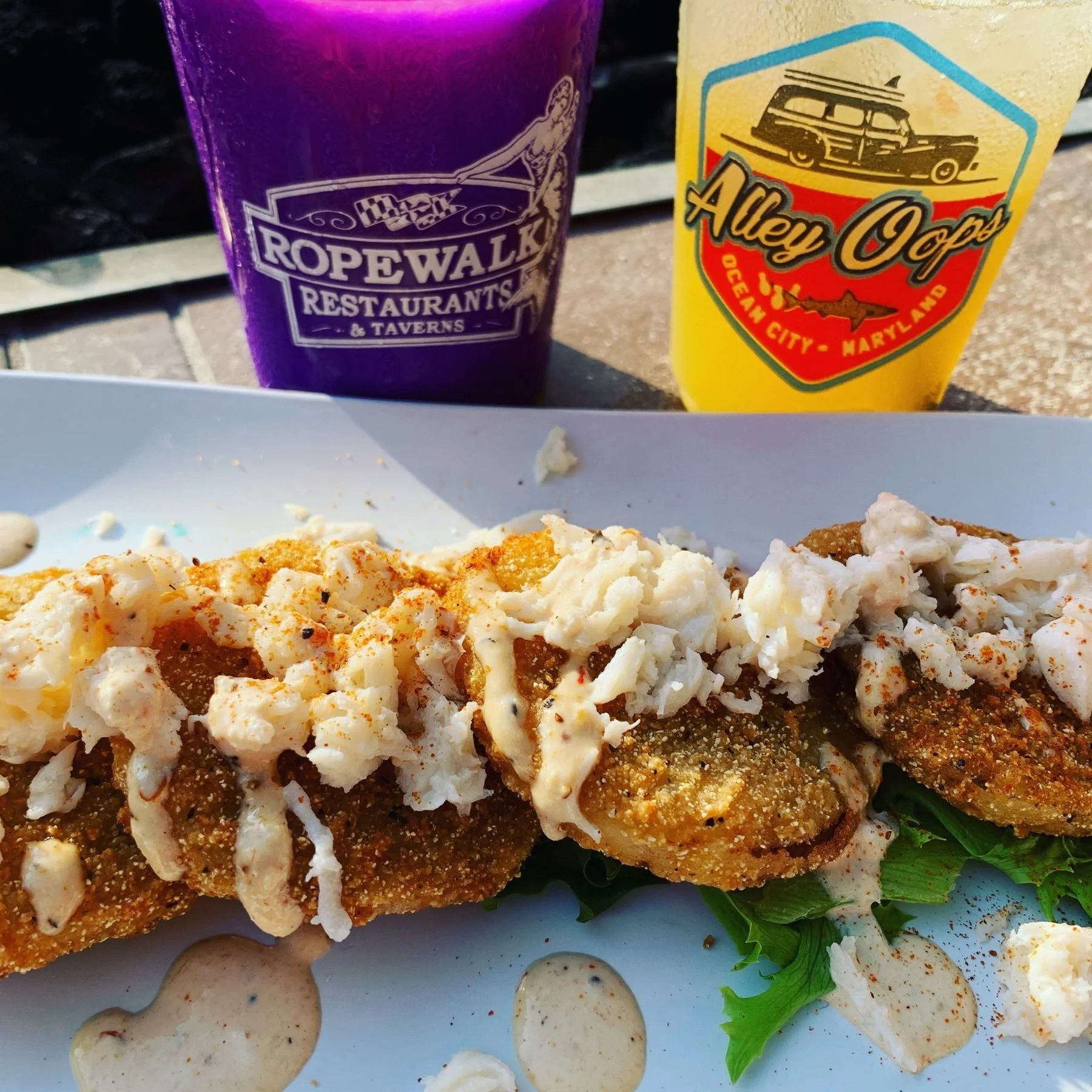 Crab-topped fried tomato appetizer in a coastal restaurant
