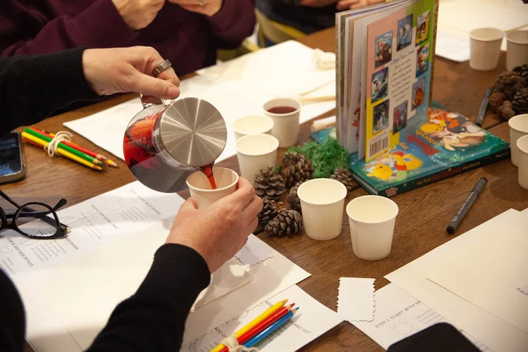 Guest pouring herbal tea on arrival at a botanical workshop in Ottawa