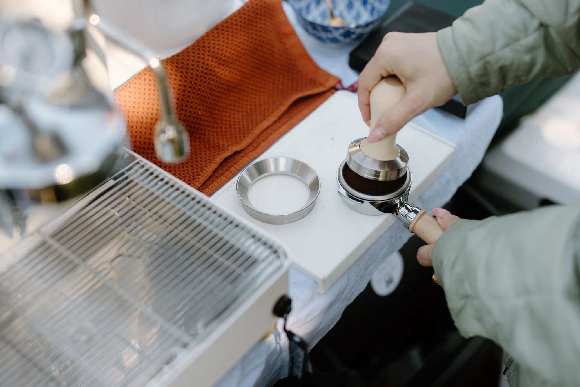 Ripley's Coffee barista tamping espresso at a mobile coffee cart for a San Diego social event