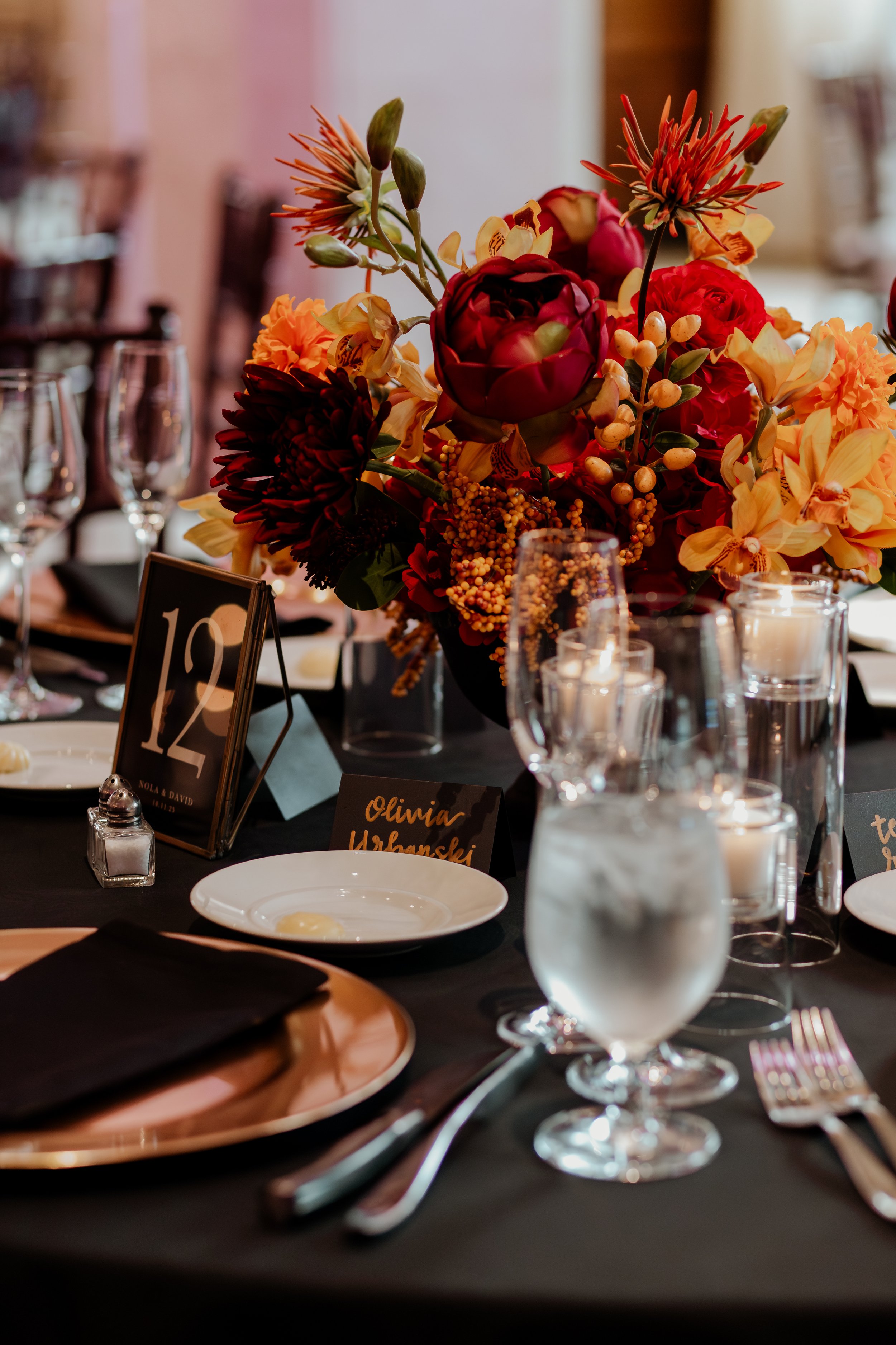 A table setting with a floral centerpiece for a wedding reception.