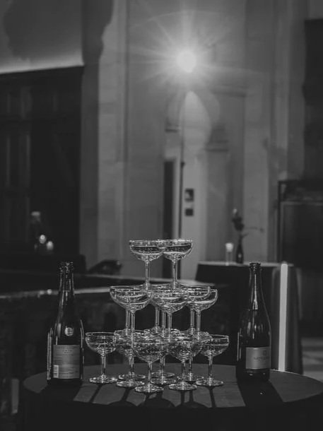 A champagne tower prepared for a bride and groom to celebrate the entrance to their wedding reception.