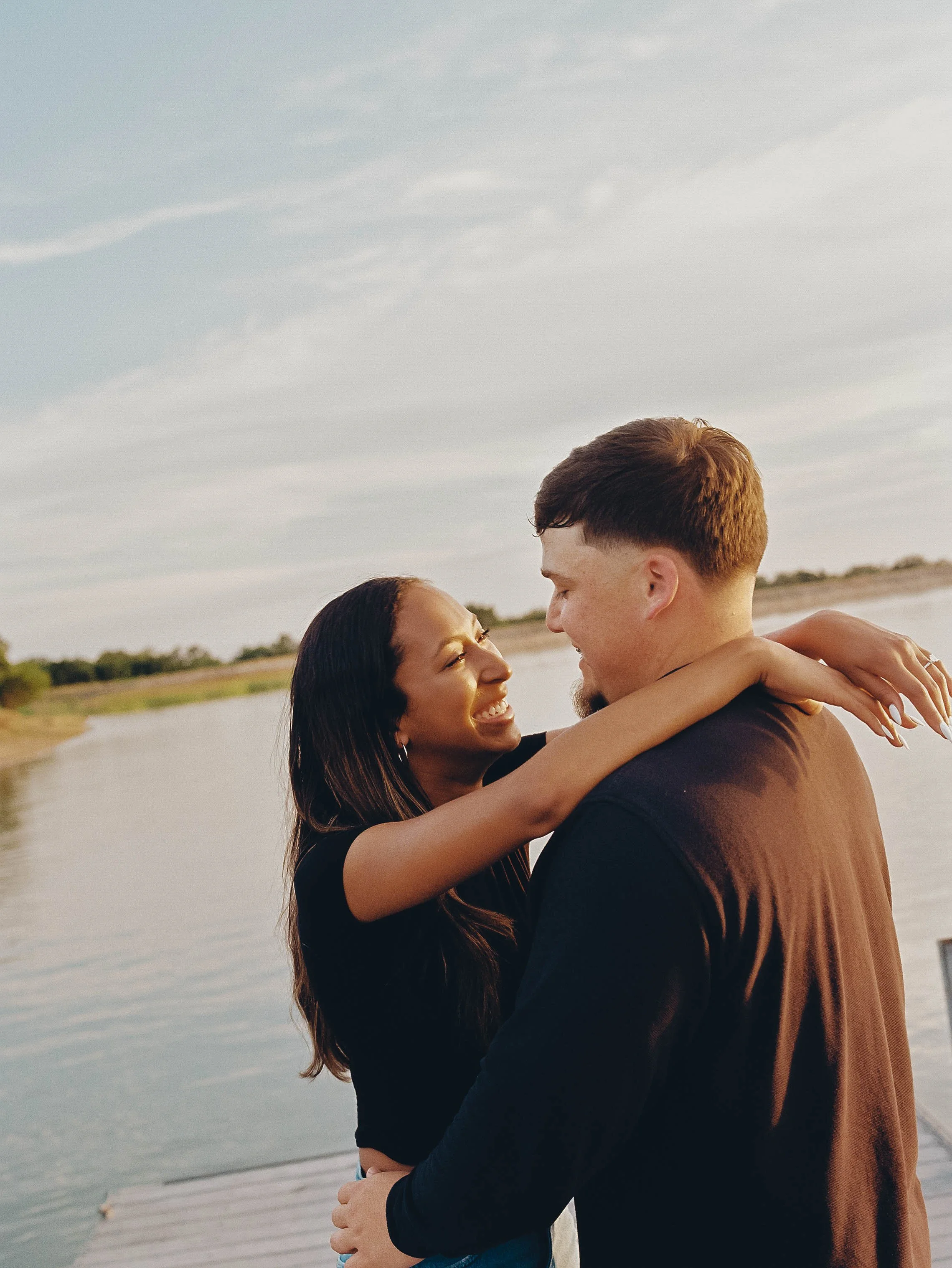 Texas lakeside summer engagement session captured on film featuring candid, romantic portraits and documentary-style storytelling.