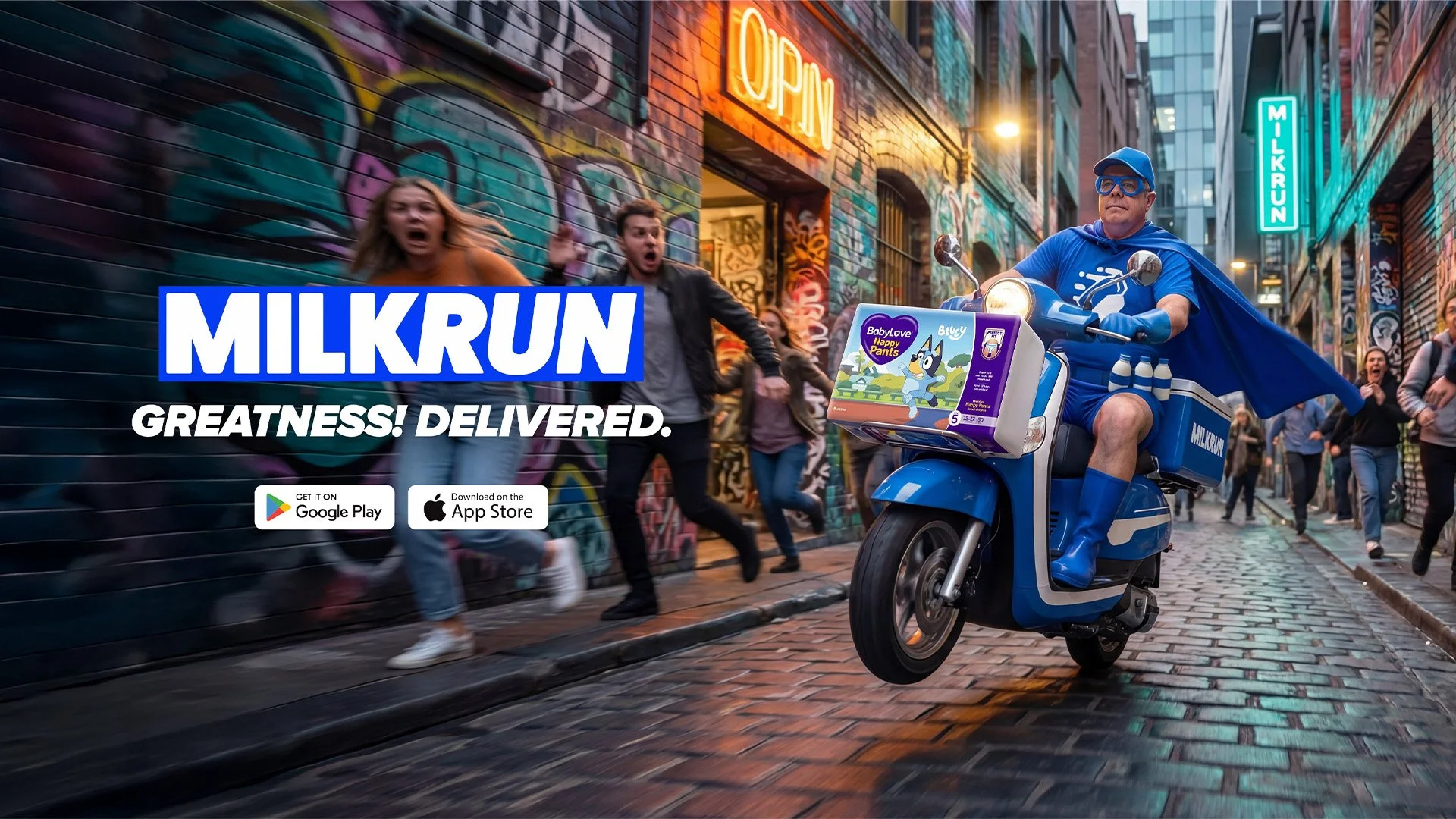 A man dressed as a superhero riding a blue scooter labeled 'MILKRUN' down a city street at dusk, with people running and a graffiti-covered wall in the background. There are signs for 'OPEN' and 'MILKRUN' neon lights, and a pack of BabyLove Nappy Pants attached to the scooter.