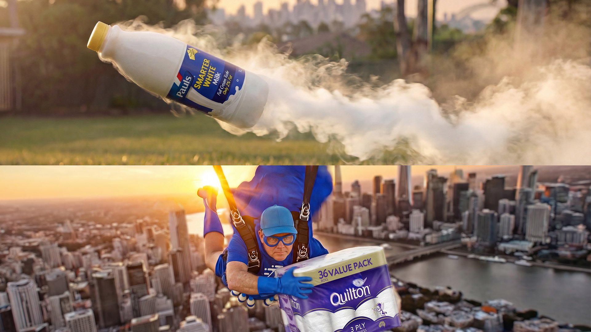 A man dressed as a superhero flying over a city skyline, holding a pack of Quilton toilet paper while wearing a blue jumpsuit, gloves, and goggles at sunset.