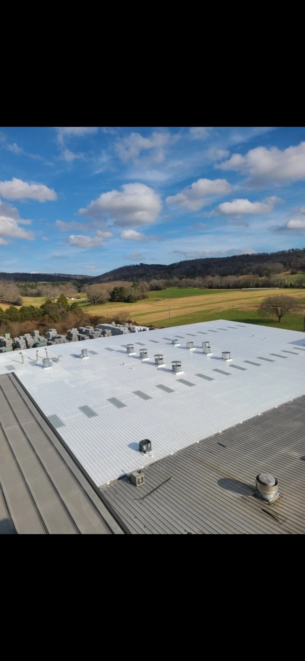 A large-scale commercial flat roof replacement featuring a white energy-efficient membrane, installed by CAMCO Roofing Services for a commercial facility in the greater Georgia area.