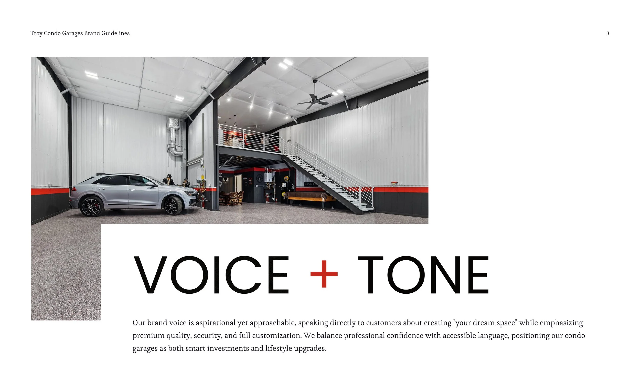 An interior view of a modern garage with a silver SUV parked inside, a staircase leading to an upper level, and industrial decor elements like pipes and black and red accents.