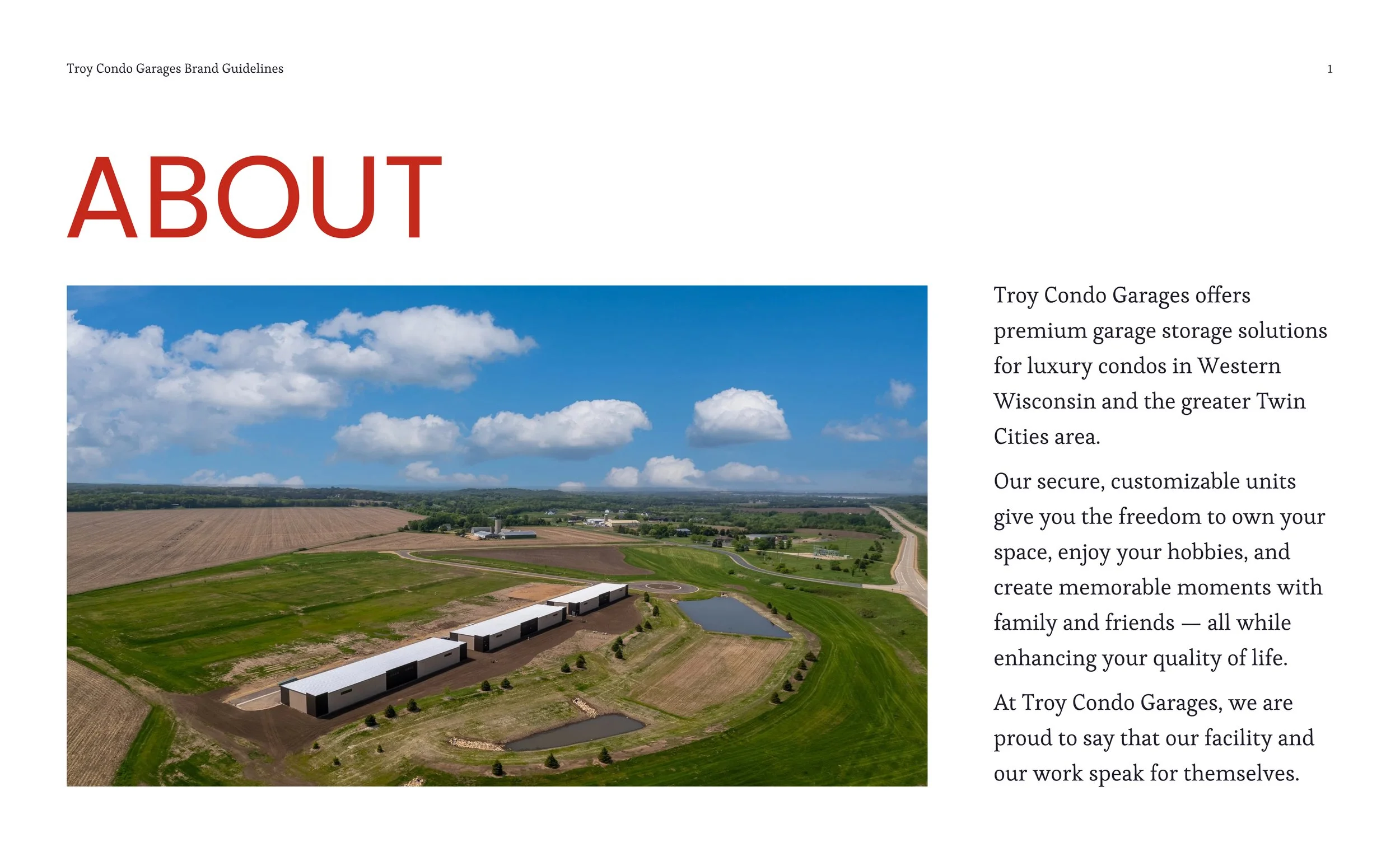 Aerial view of a storage facility with multiple garage units surrounded by farmland, green fields, and a blue sky with fluffy clouds.