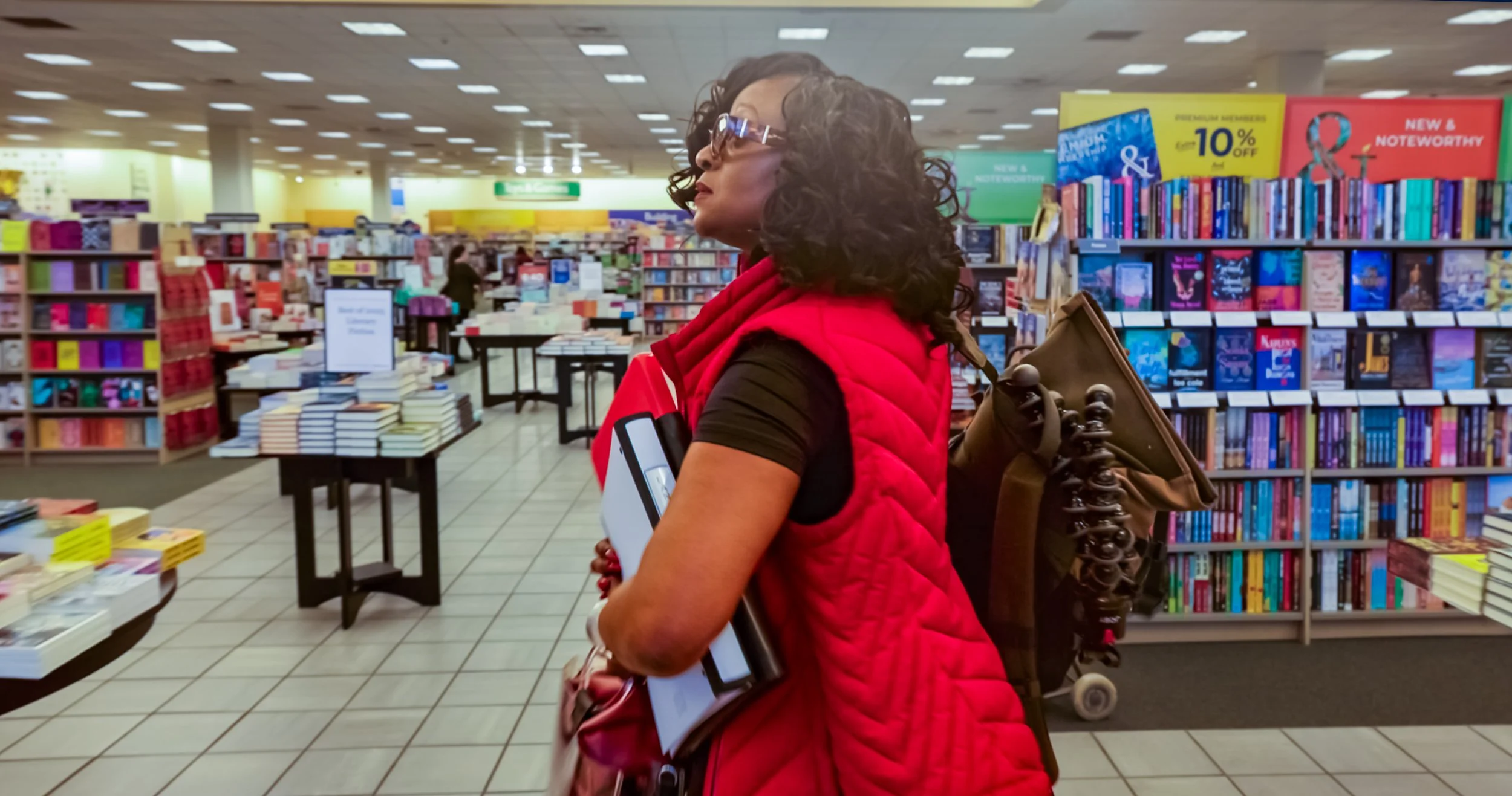 Najya Mawasi holding books at Barnes & Noble as part of her visual thesis work on communication and storytelling.