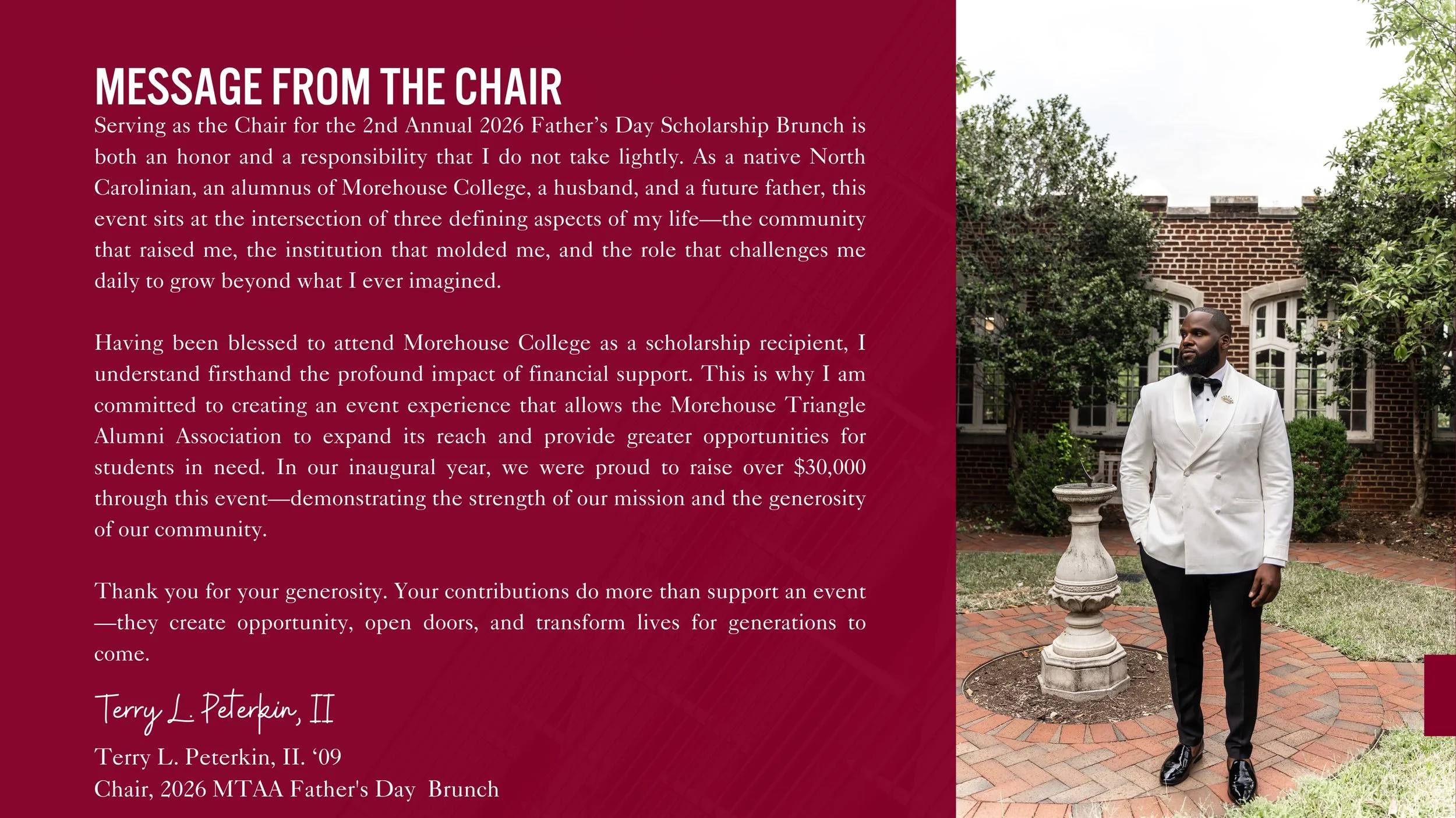 Man dressed in a white tuxedo jacket, black pants, and black shoes, standing outdoors on a brick pathway next to a decorative stone fountain, with green trees and a brick building in the background.