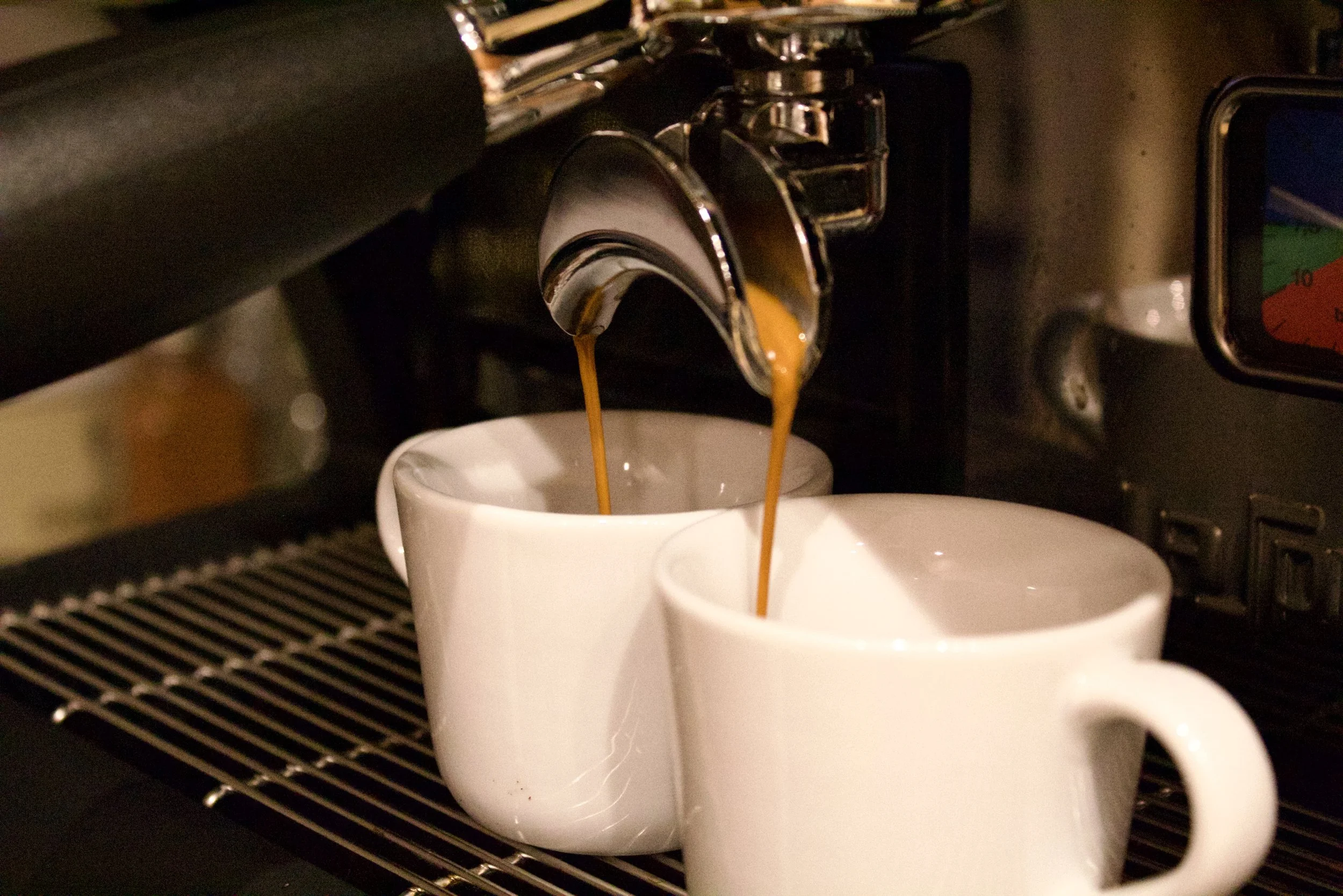 Espresso shots pouring into ceramic cups at Milk n Honey Coffee Company’s mobile coffee bar serving Minneapolis and Twin Cities events.