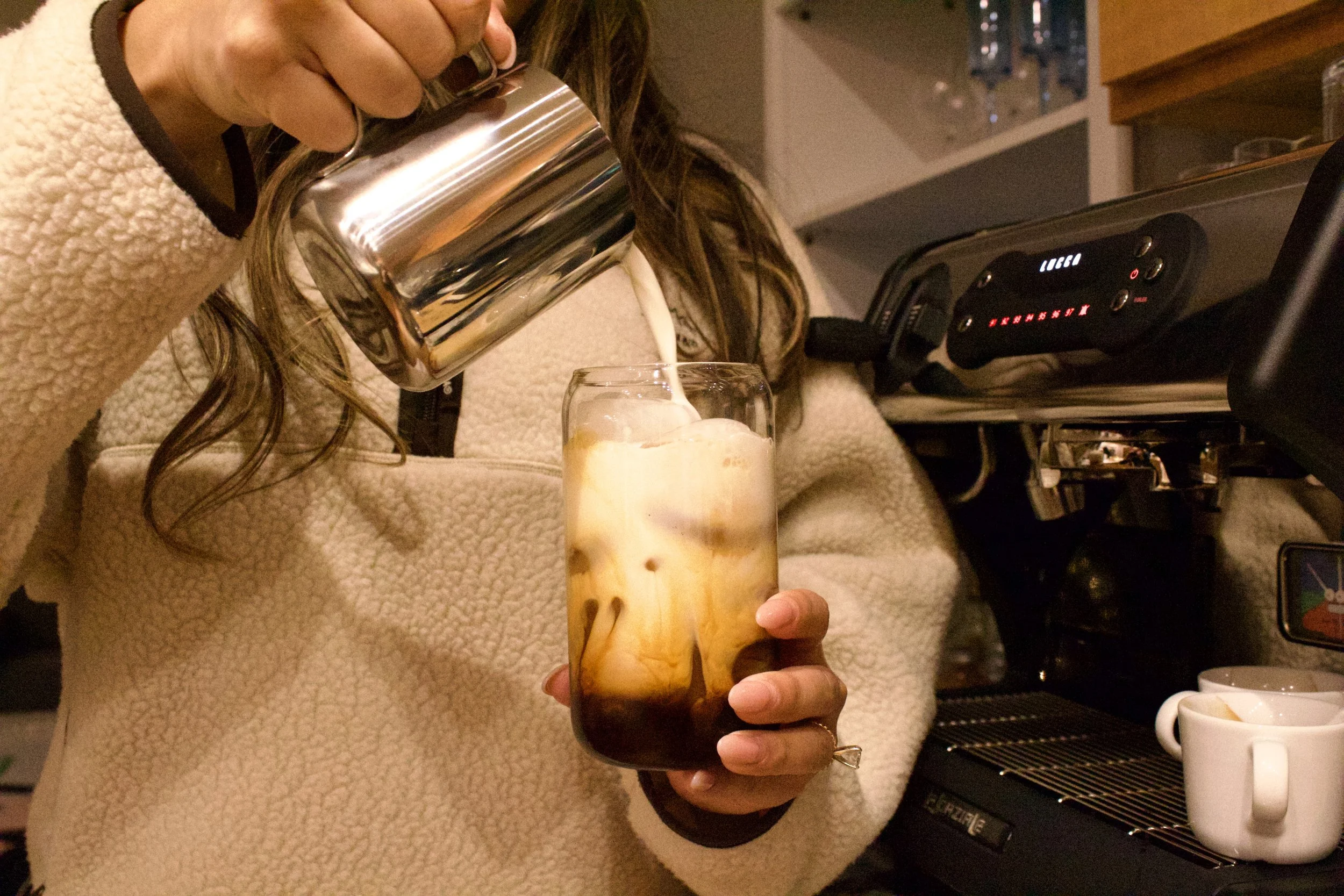 Iced latte being prepared at Milk n Honey Coffee Company’s mobile coffee cart, offering handcrafted espresso drinks at Minnesota weddings and events.