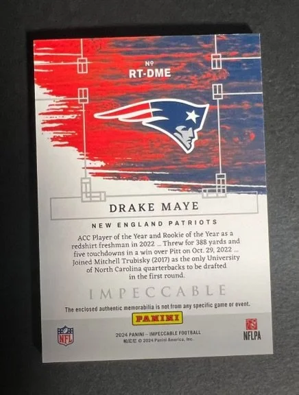 Football trading card featuring Drake Maye, New England Patriots. The card has a red and blue background with a Patriot logo in the center. It includes details about Drake Maye, an NFL rookie quarterback, and mentions his achievements and draft infor