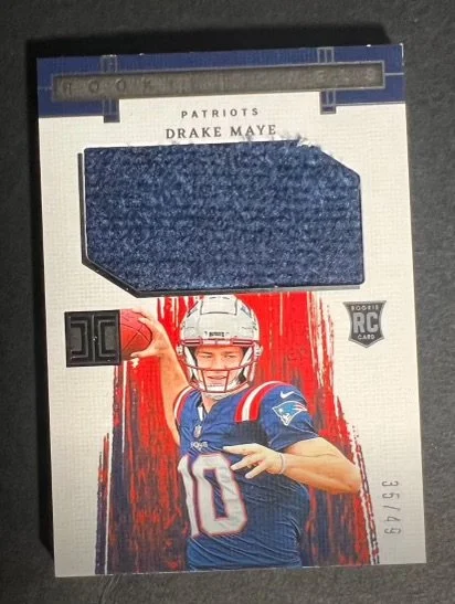 Sports trading card of Patriots player Drake Maye, featuring a fabric swatch and an image of the player in a Patriots uniform.